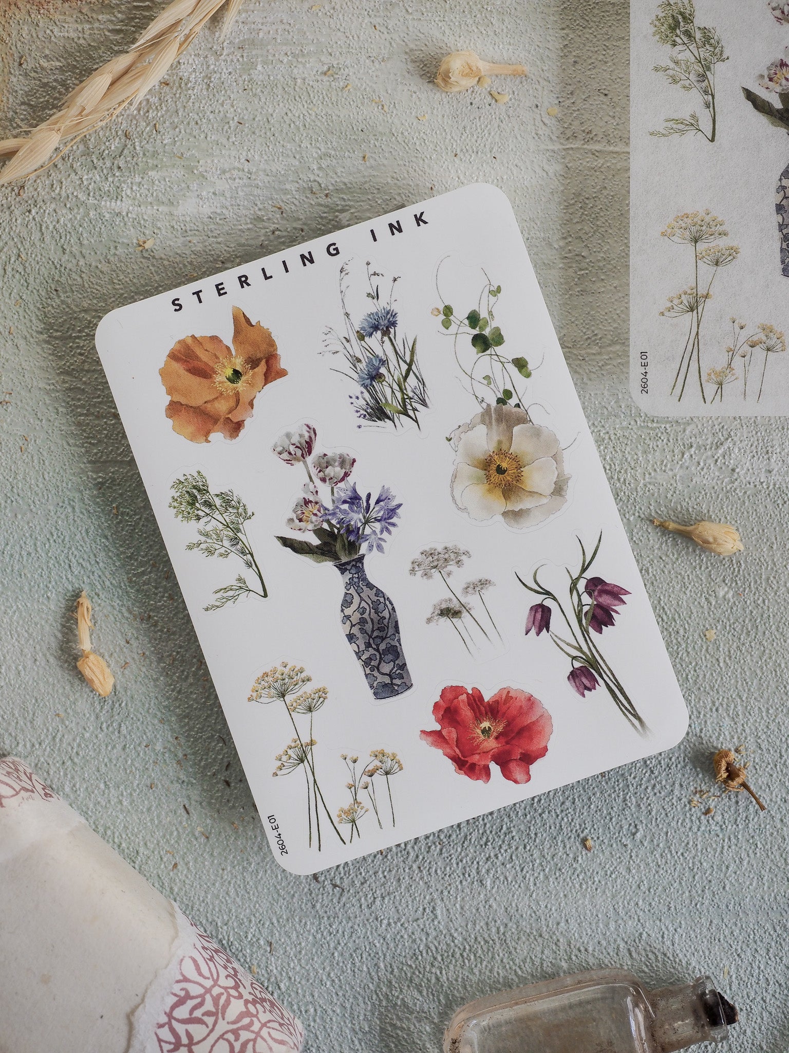 Botanical elements sticker sheet featuring watercolor illustrations of diverse flowers, leaves, and plant studies on a clean white background.