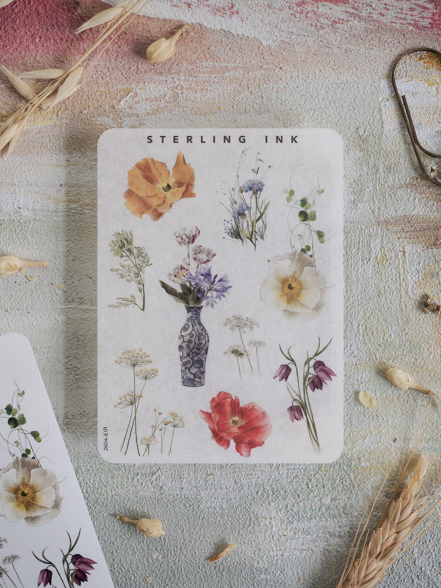 Watercolor floral sticker sheet featuring an elegant arrangement of botanical elements like poppies, lilies, and delicate wildflowers from the 'Elements Stickers' collection.