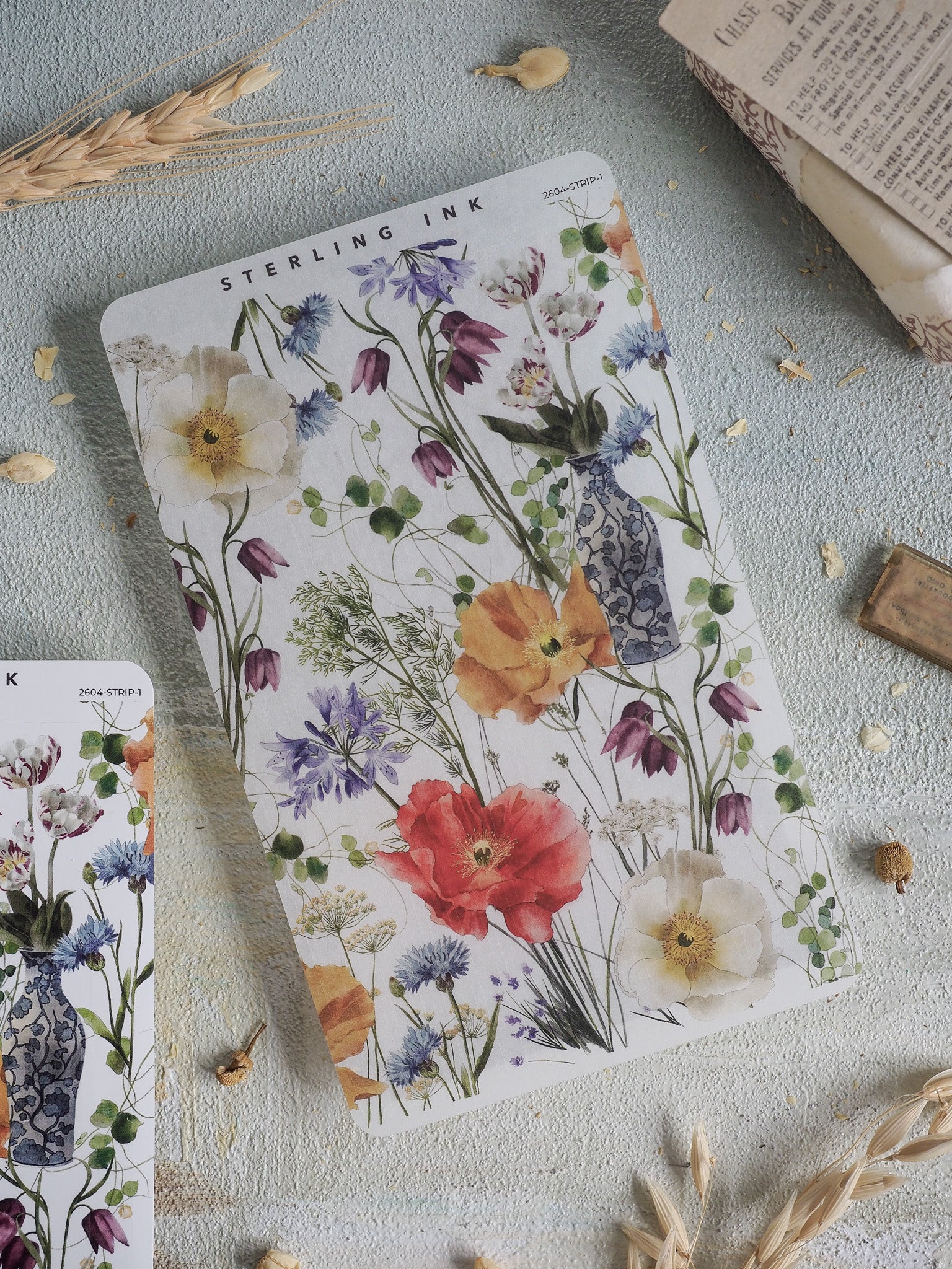 Vibrant watercolor floral sticker strip featuring a lush bouquet of spring blooms, including poppies and tulips, in shades of red, blue, and yellow.