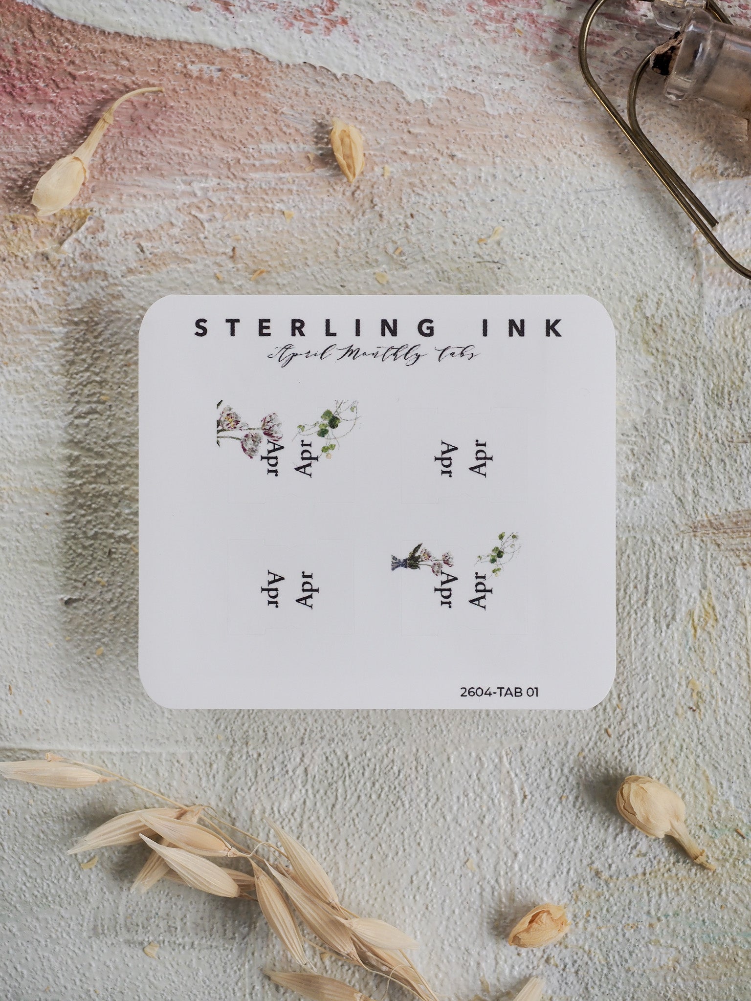 Decorative set of Sterling Ink monthly tabs for April, featuring delicate botanical illustrations perfect for organizing a planner or journal.