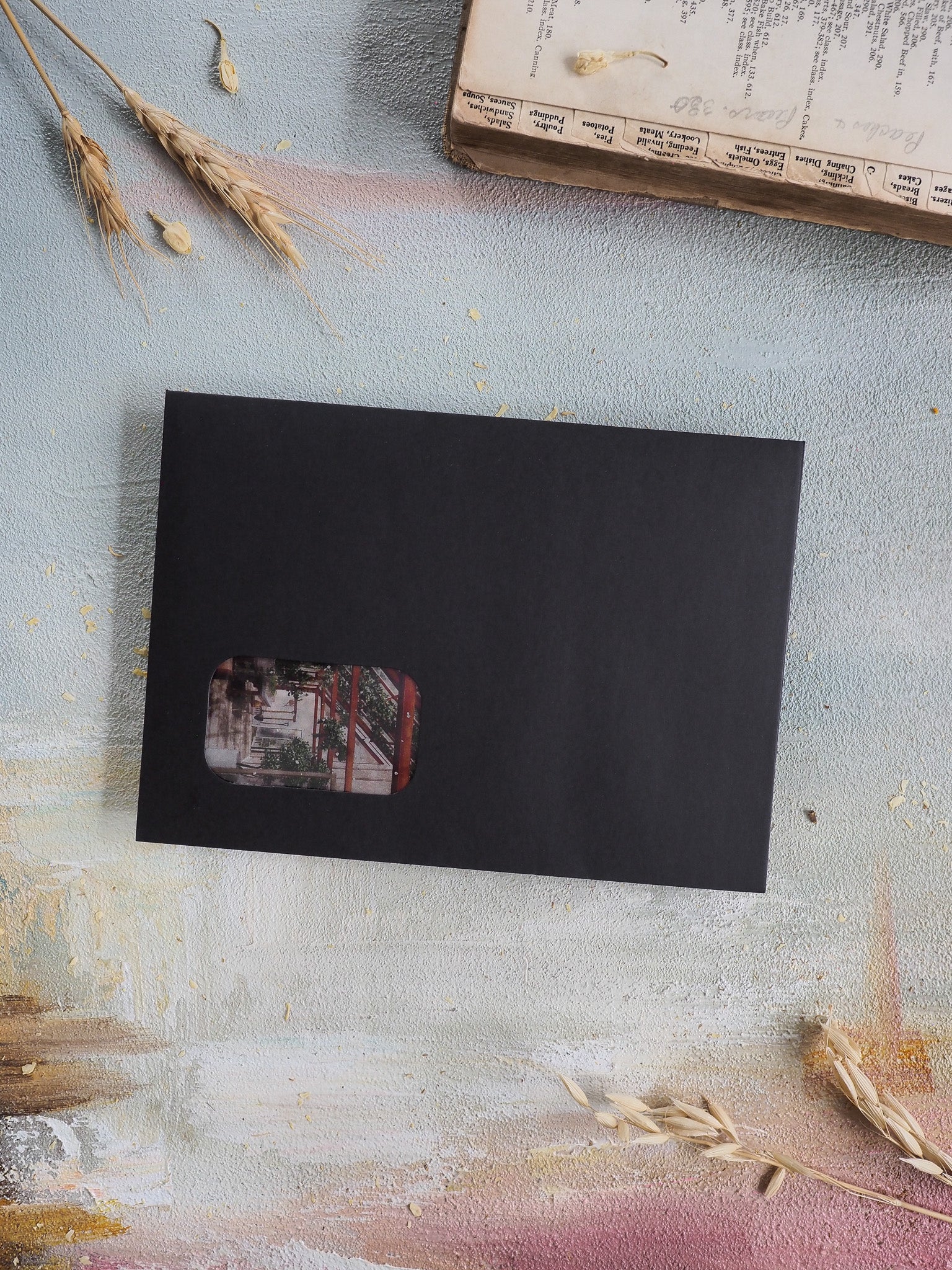 Minimalist black card featuring a centered, faded, vintage-style photograph graphic for the April 2026 subscription kit collection.