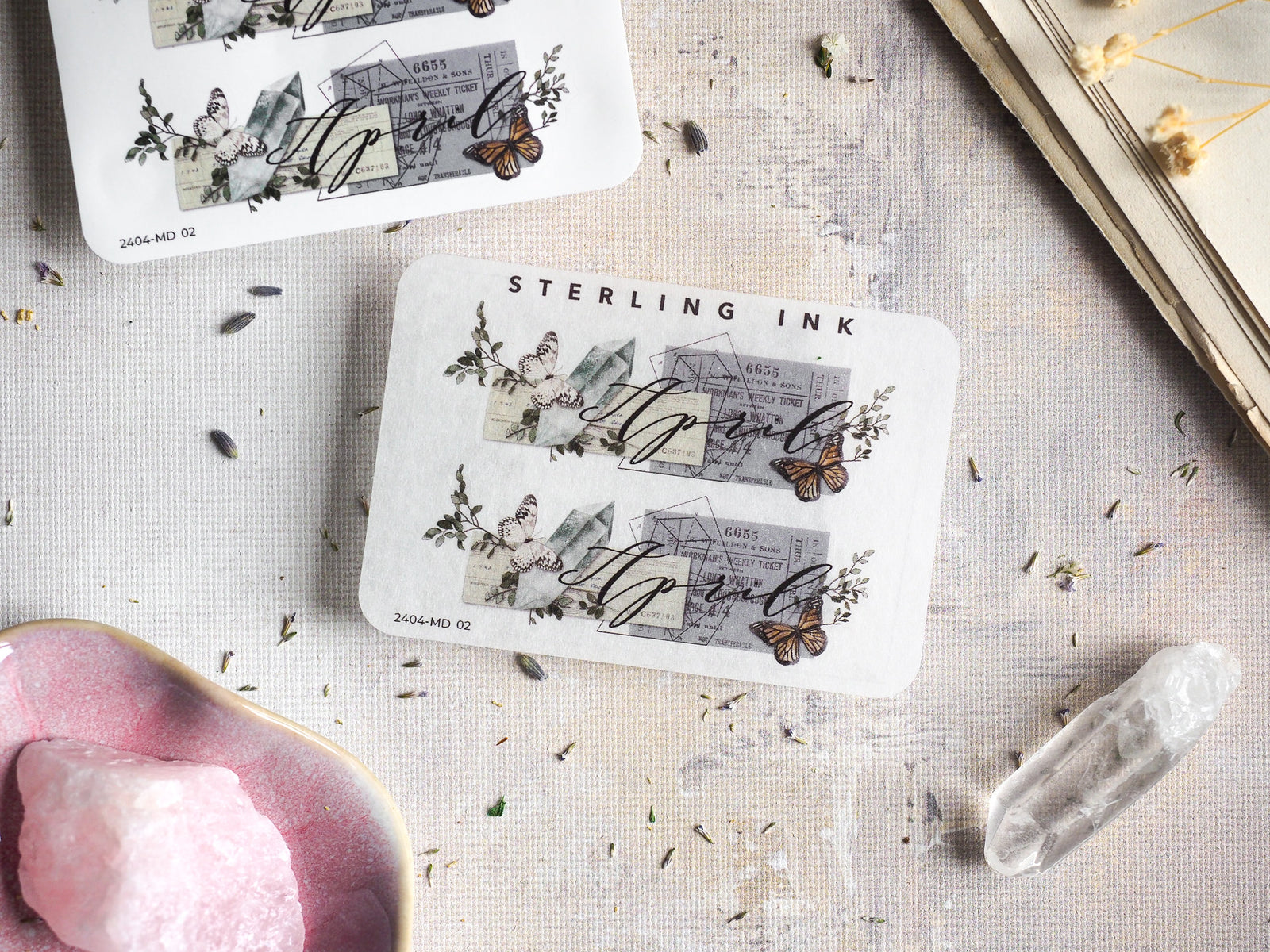 Decorative April 2024 month sticker with a vintage aesthetic, printed in black ink featuring engraved architectural details, delicate floral motifs, and charming butterflies.