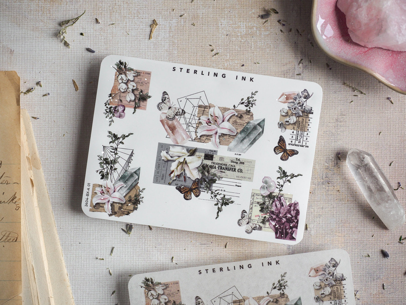 Sterling Ink sticker sheet featuring a rich vintage design of pressed botanical elements, butterflies, and aged corner ephemera with silver foil accents.