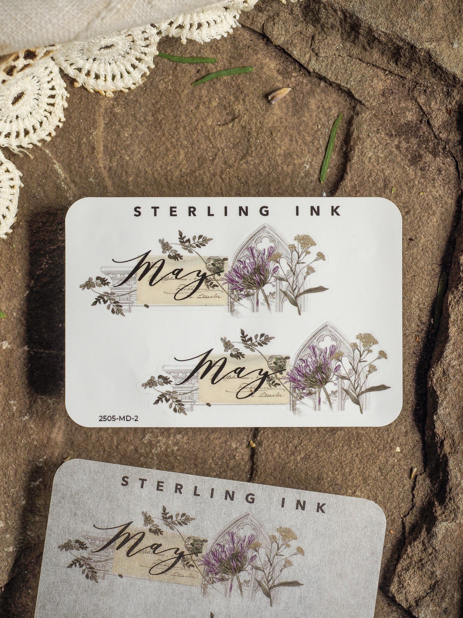Elegant "May" month sticker set featuring botanical illustrations of deep purple lavender and delicate greenery on cream paper for journaling and scrapbooking.