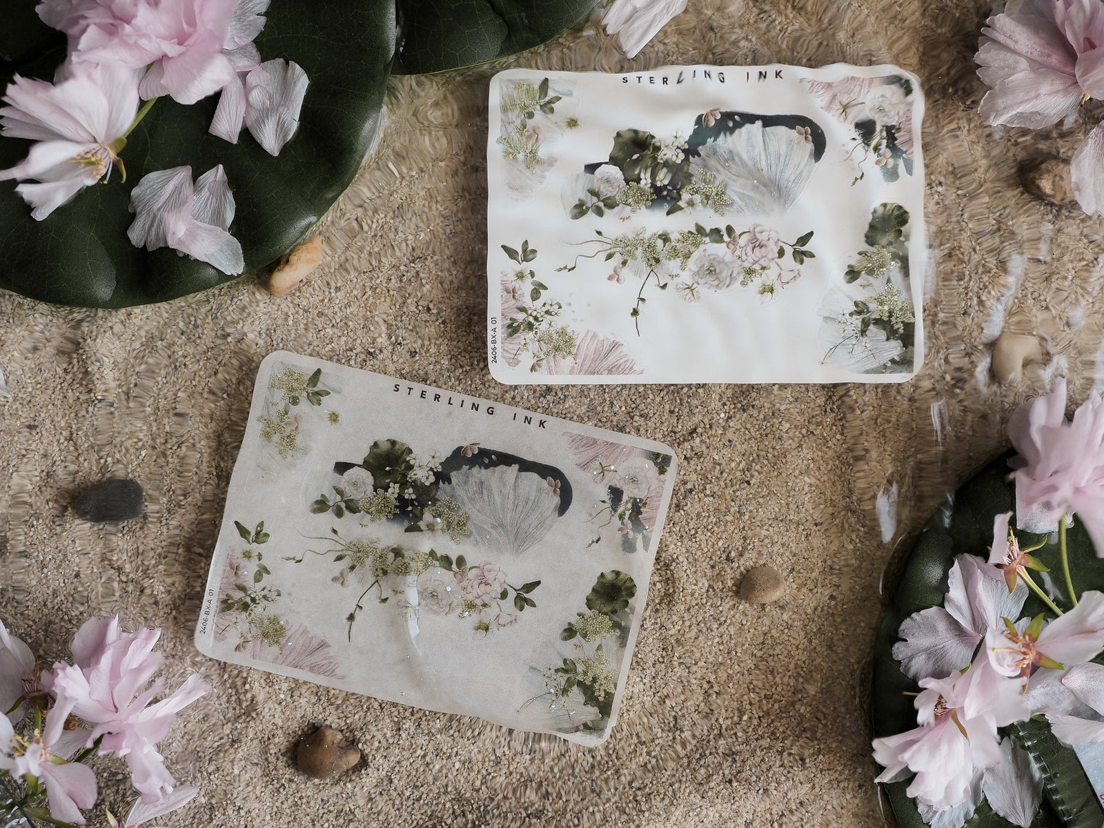 Delicate pale sticker strips featuring a detailed, faded botanical pattern of greenery and muted watercolor flowers, branded with "STERLING INK."