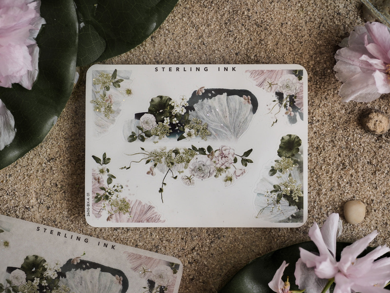 Delicate botanical sticker sheet featuring clustered designs of pale pink and white roses, leafy vines, and shimmering holographic floral accents for journaling.