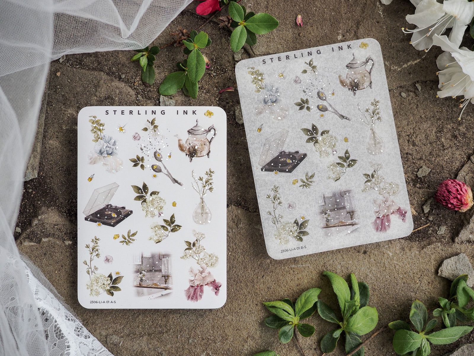 Set of large, white icon sticker sheets with silver foil accents, displaying a curated collection of botanical, vintage, and decorative crafting elements.