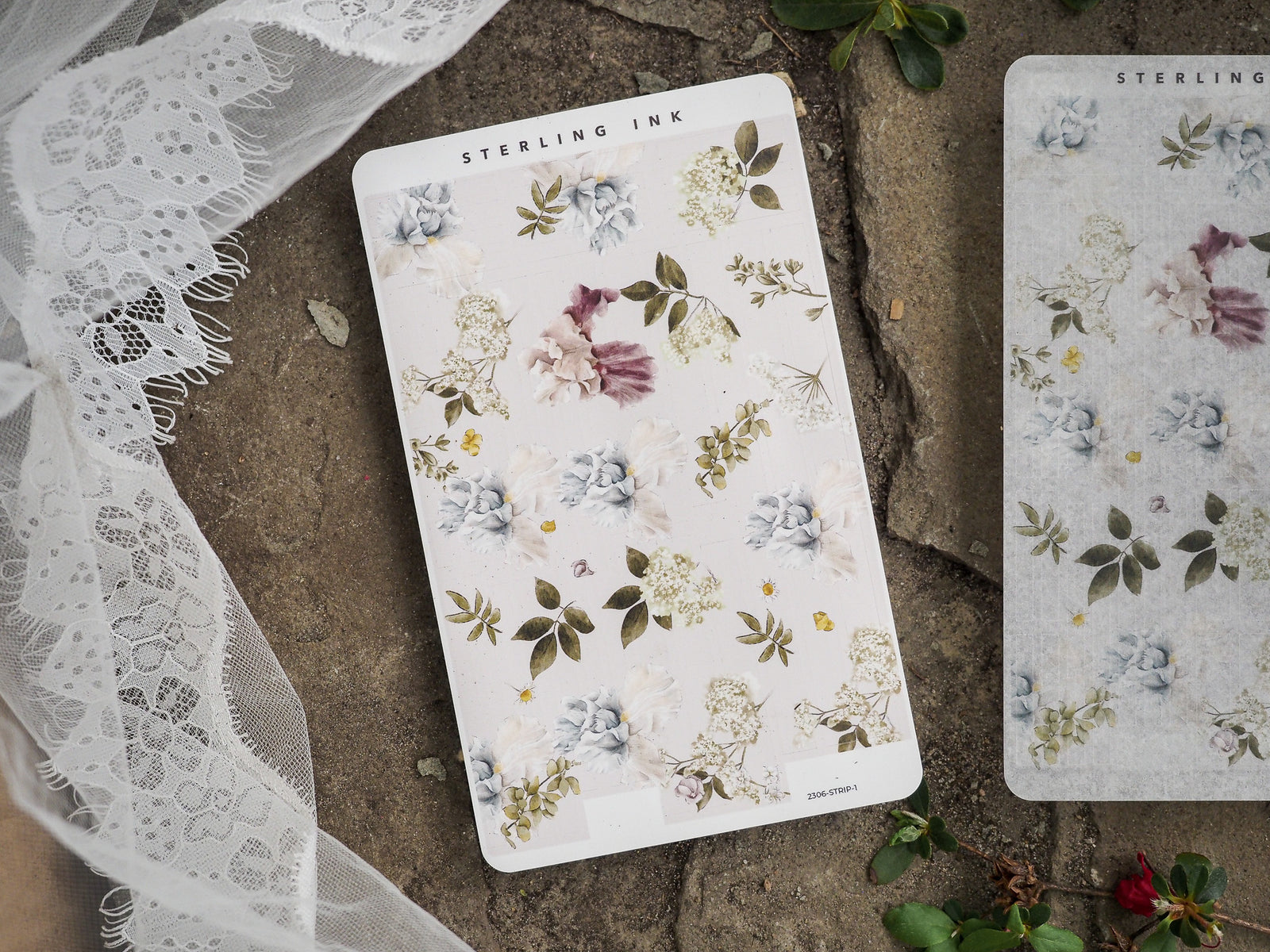 Scrapbook stickers featuring a soft, romantic botanical pattern of pale blue, blush pink, and cream flowers surrounded by fresh green foliage.