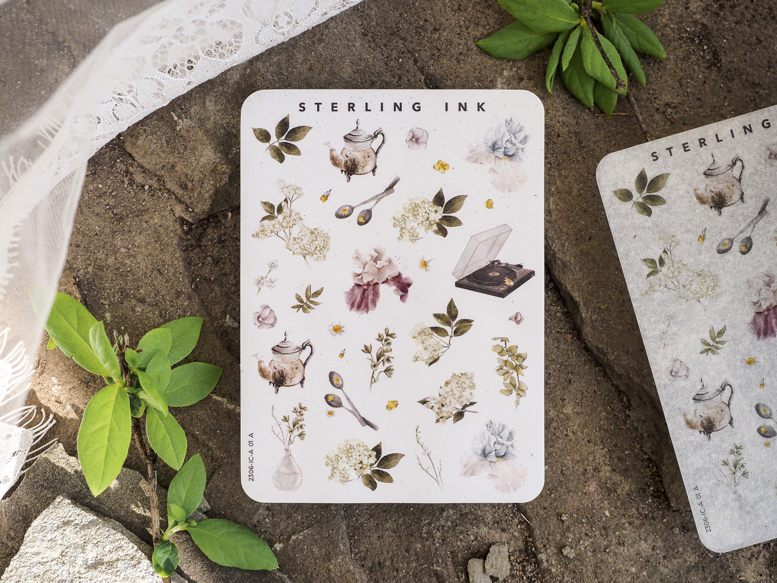 Delicate sticker sheet featuring miniature watercolor icons of botanical elements, vintage teapots, dried flowers, and ink accents for journaling and crafts.