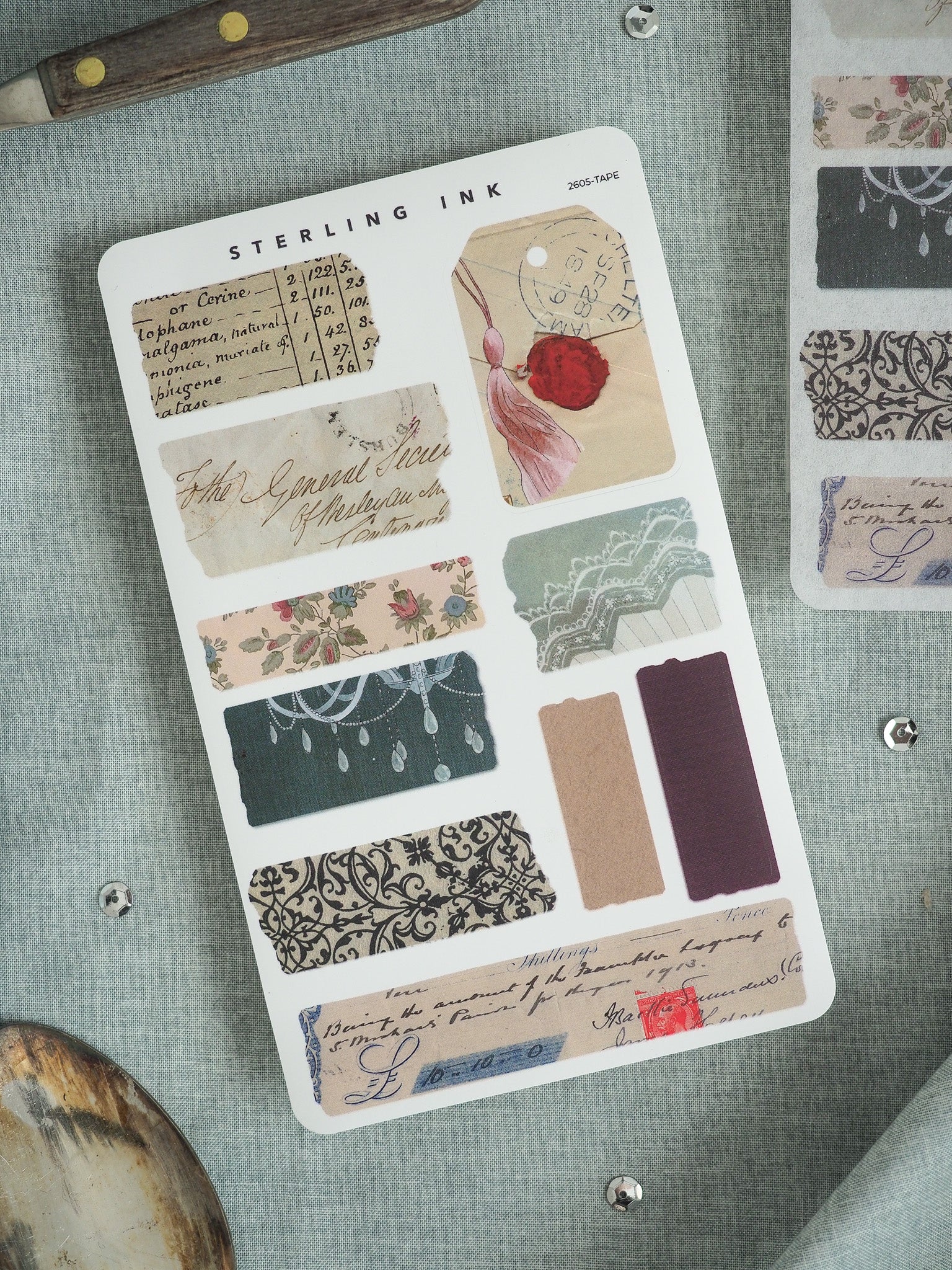 Vintage ephemera sticker sheet with patterns mimicking antique documents, featuring floral designs, distressed text labels, and solid craft tape strips for journaling and scrapbooking.