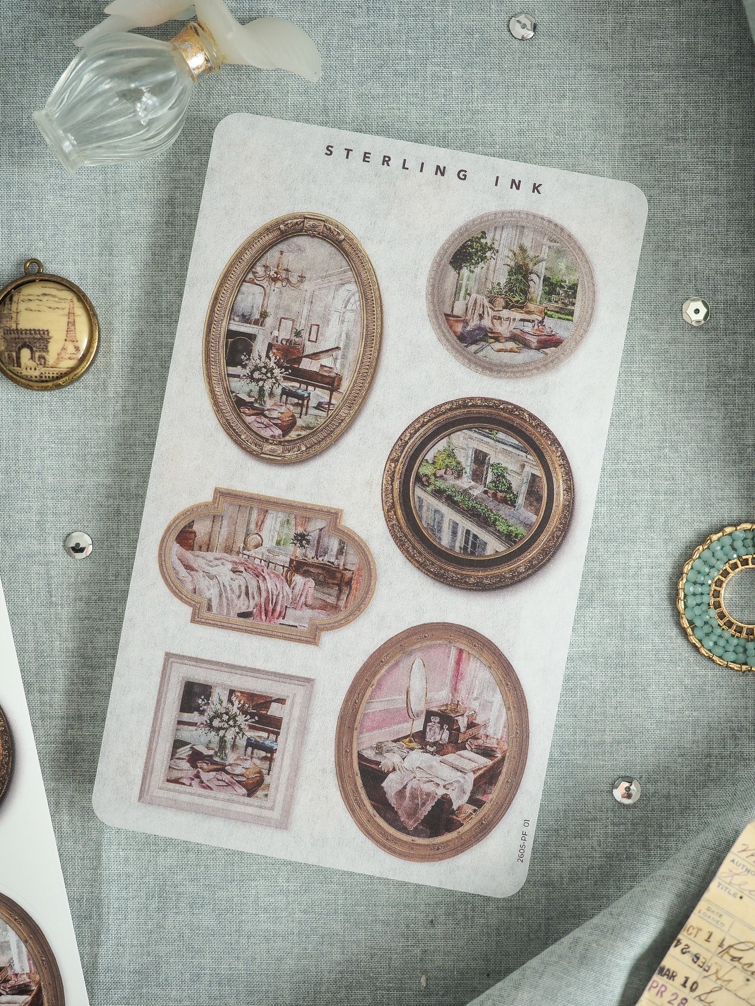 Rectangular "STERLING INK" card featuring six framed, vintage-style circular illustrations depicting cozy and elegant historical interior rooms and dining settings.