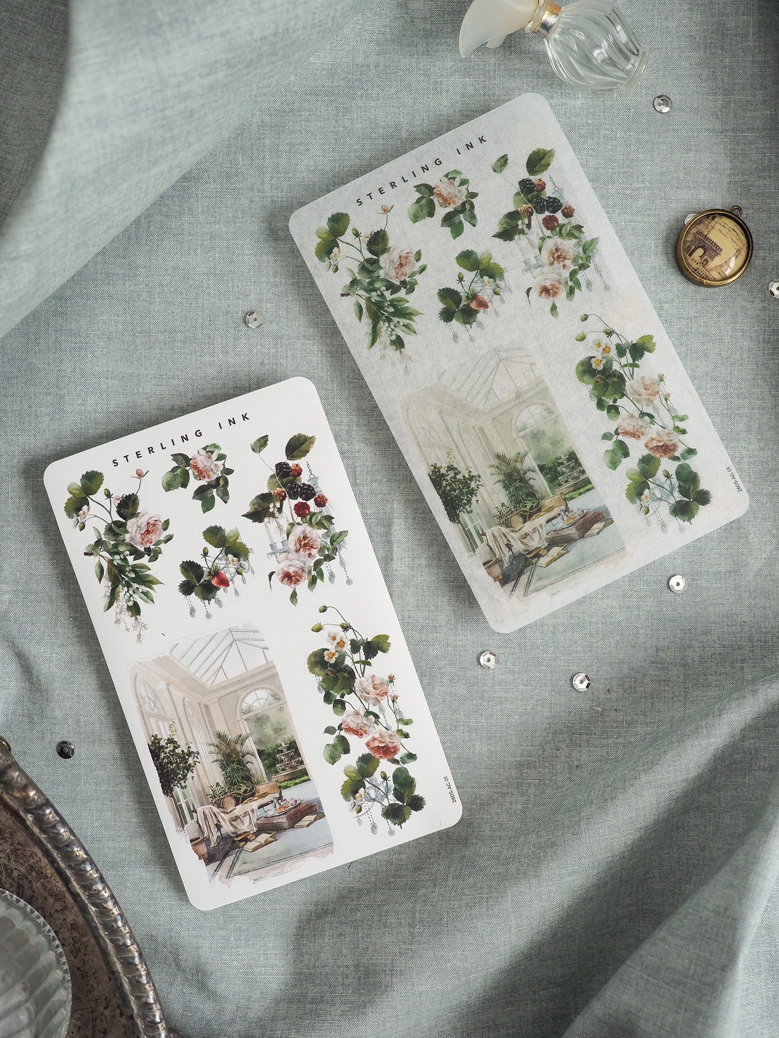 Elegant watercolor sticker sheets featuring lush botanical arrangements, roses, berries, and vintage conservatory scenes from Sterling Ink.