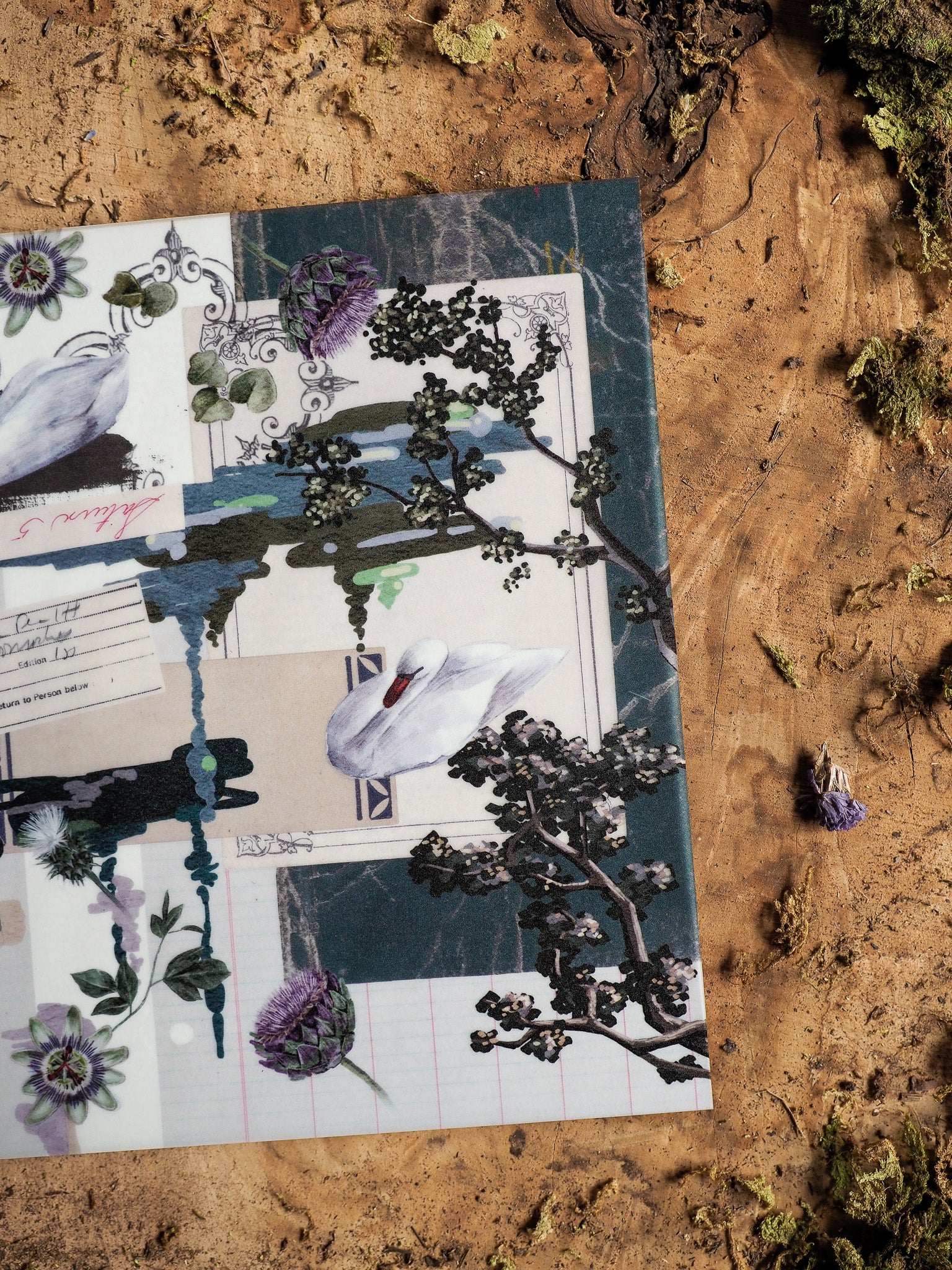 Planner cover featuring a collage design with white swans, purple florals, and blooming plum branches set against deep indigo and patterned backgrounds.