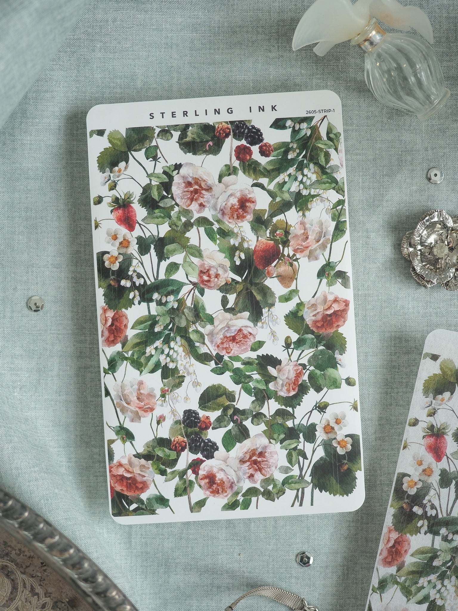 Botanical pattern sheet featuring lush watercolor depictions of pink and white roses mixed with green foliage, strawberries, and dark blackberries.