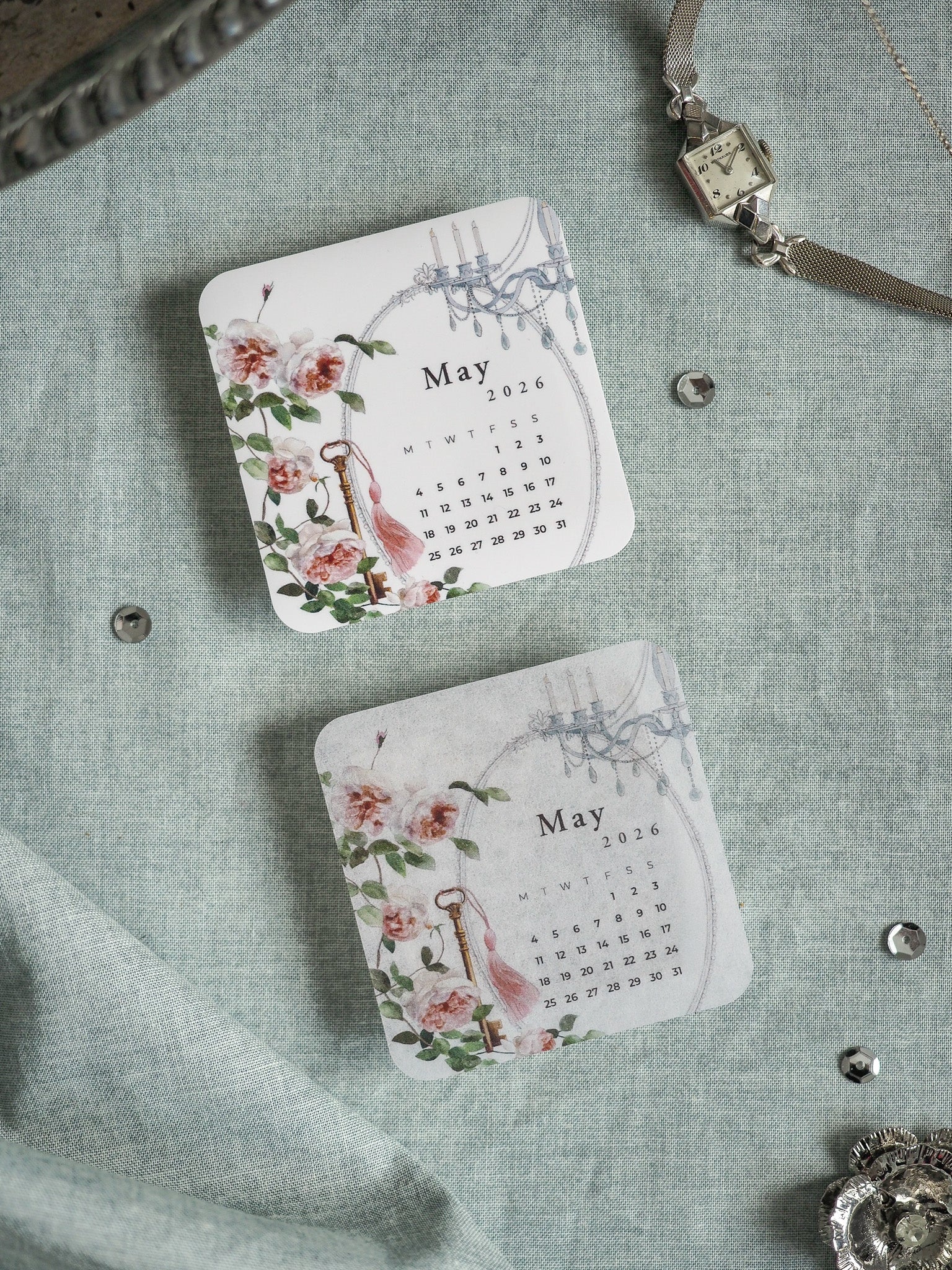 Romantic May 2026 printable calendar featuring watercolor roses and lush green floral accents on a decorative card layout.