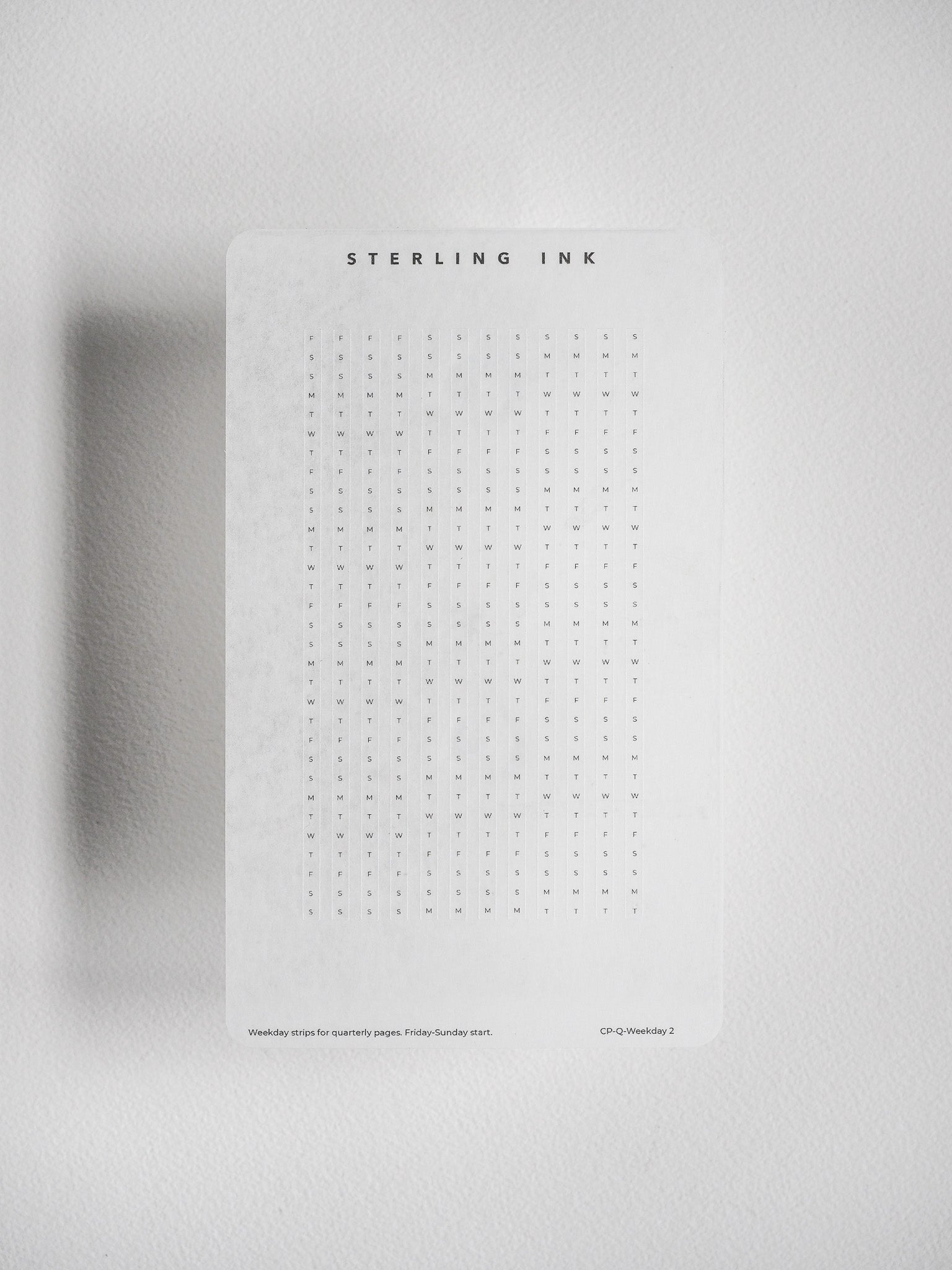 Functional sticker sheet with black text patterns of labeled weekdays, designed for organizing undated planners and tracking quarterly journaling.