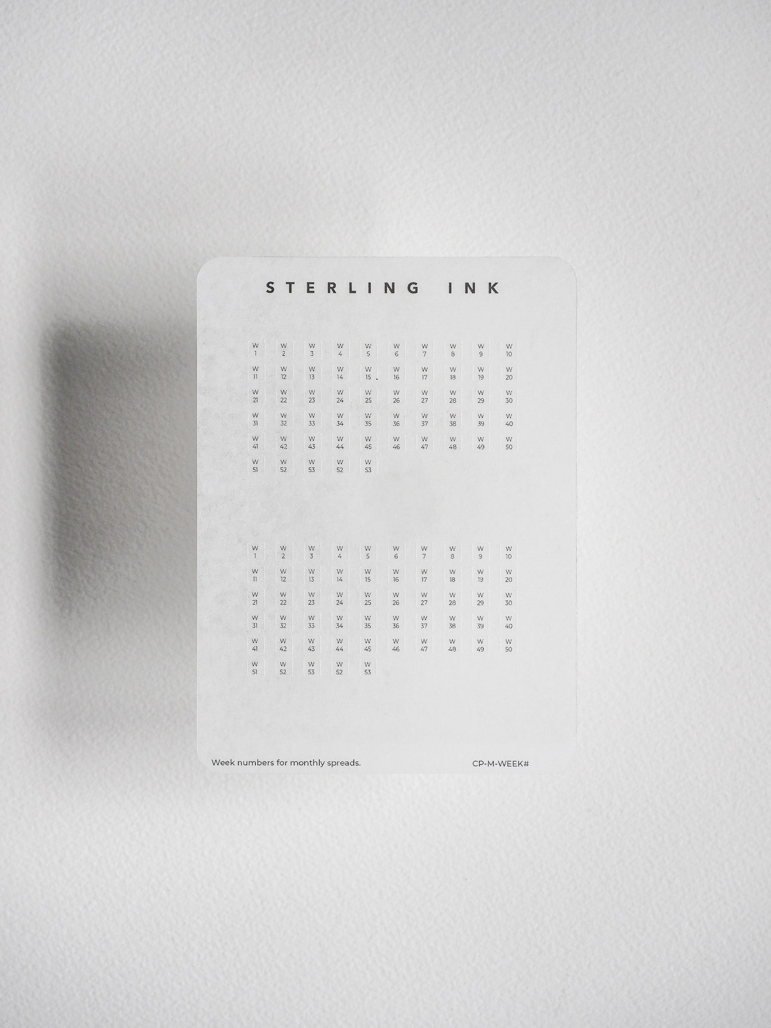 A structured, white planning sheet with a calendar grid layout, providing labeled week numbers (1–53) for undated, compatible planner use.