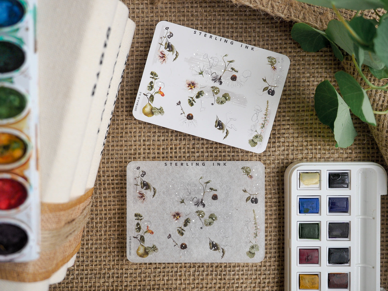 Botanical sticker sheets featuring delicate drawings of tiny flowers, berries, and leaves, perfect for journaling and craft embellishment.
