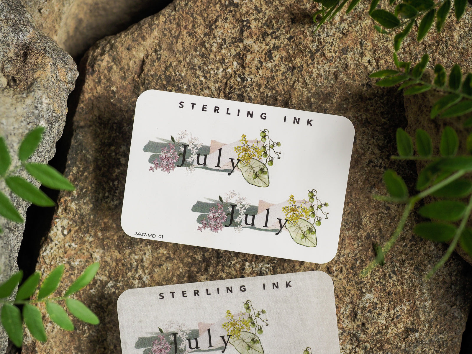 Charming "July" month sticker decorated with delicate watercolor bouquets of pink, green, and yellow floral accents for planners.