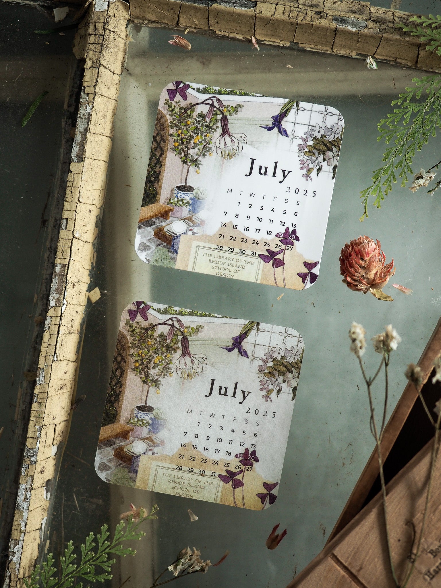 Two matching July 2025 monthly calendars featuring a delicate botanical design with purple and yellow wildflowers.