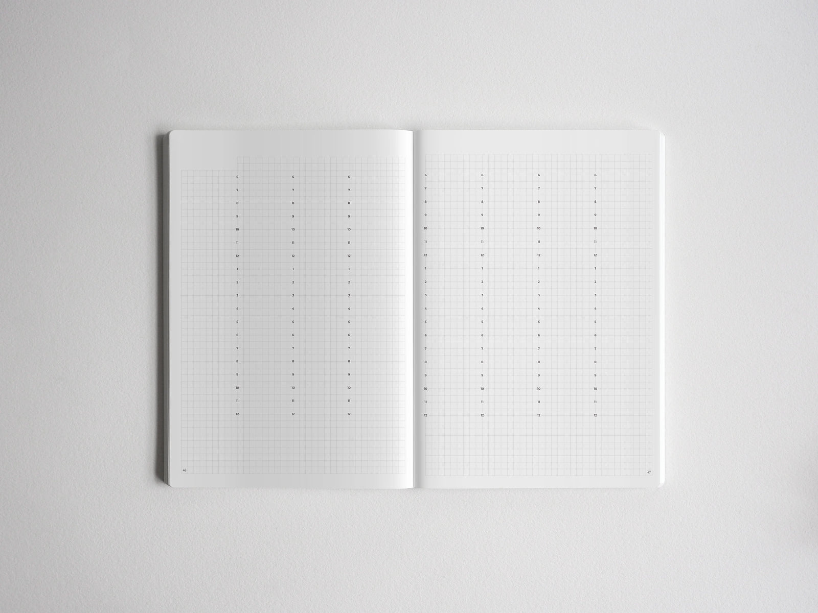 Open journal notebook open to two pages of white graph paper, ideal for academic notes, bullet journaling, or structured planning.