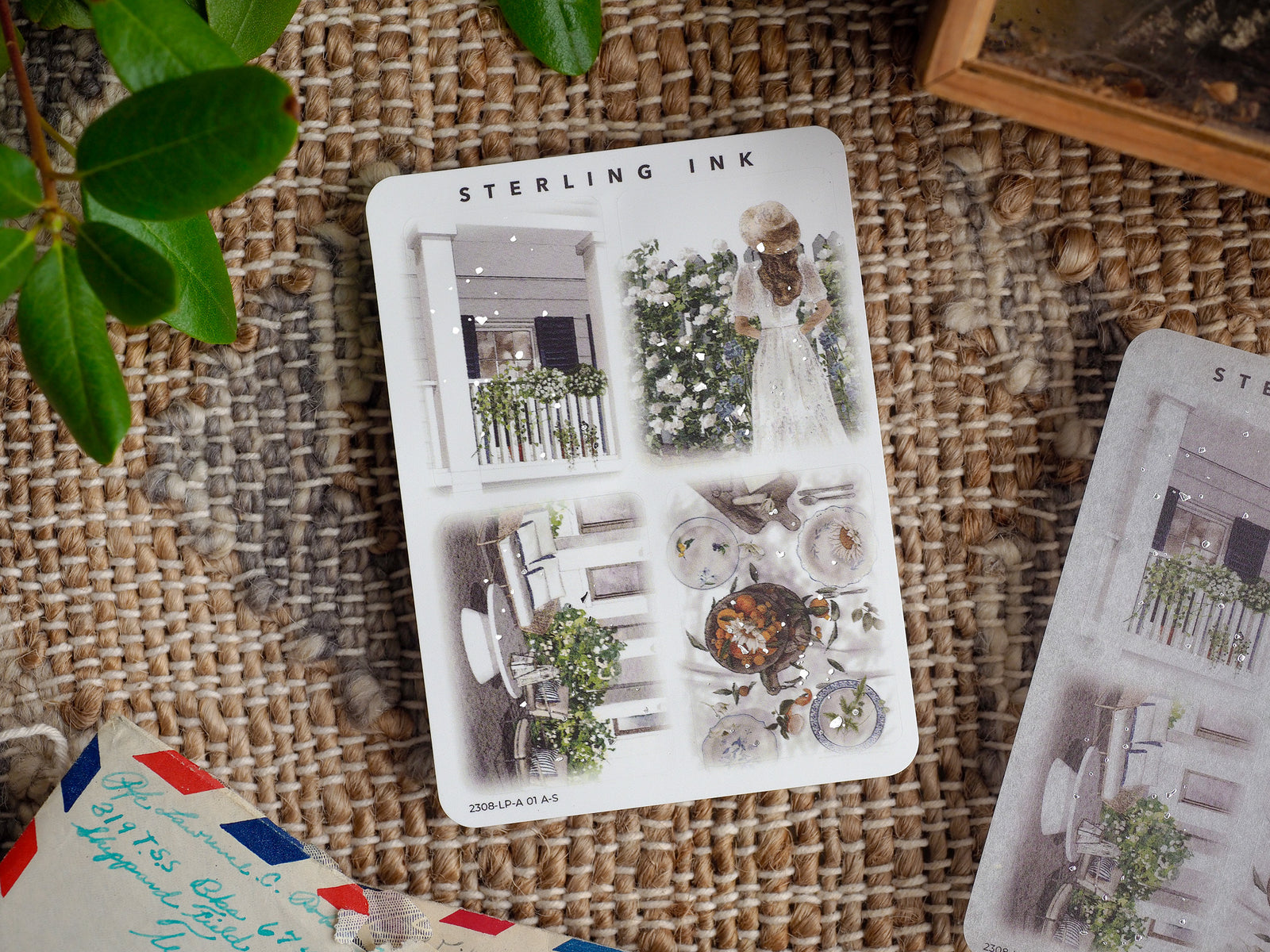 A sheet of large, illustrative die-cut stickers featuring silver foil accents and romantic themes like detailed garden decor, patio scenes, and whimsical floral designs.