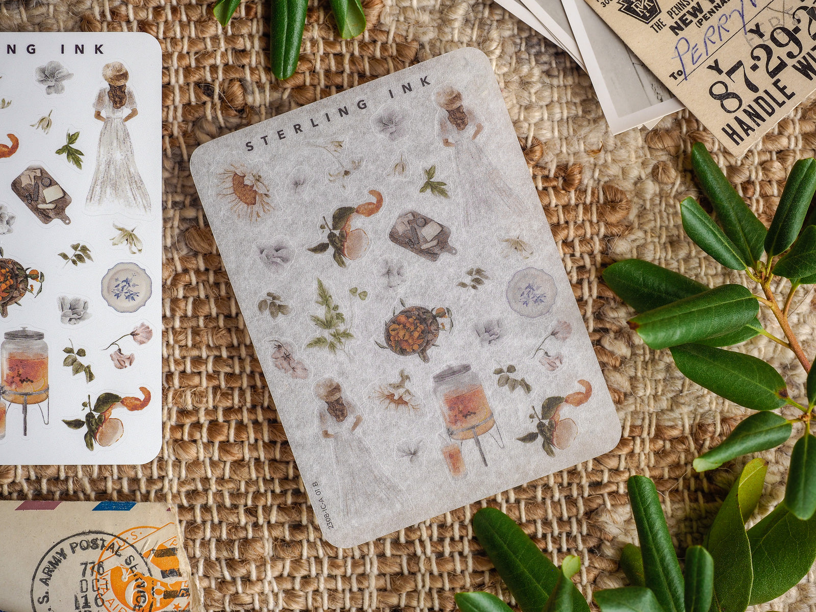 Detailed mini sticker sheets featuring a pattern of nature elements, including insects, florals, and rustic icons, in muted, vintage tones.