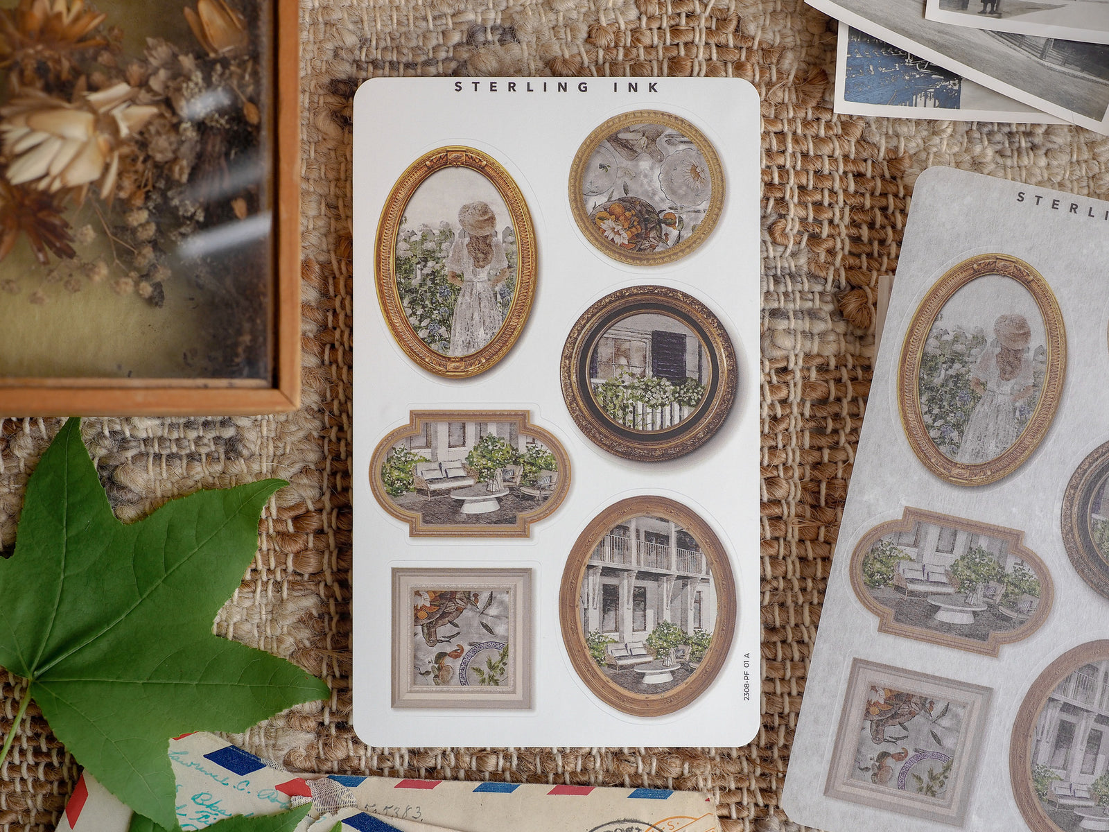 Vintage-themed sticker sheet featuring diverse picture frame designs and die-cut borders surrounding detailed architectural and portrait illustrations for scrapbooking.