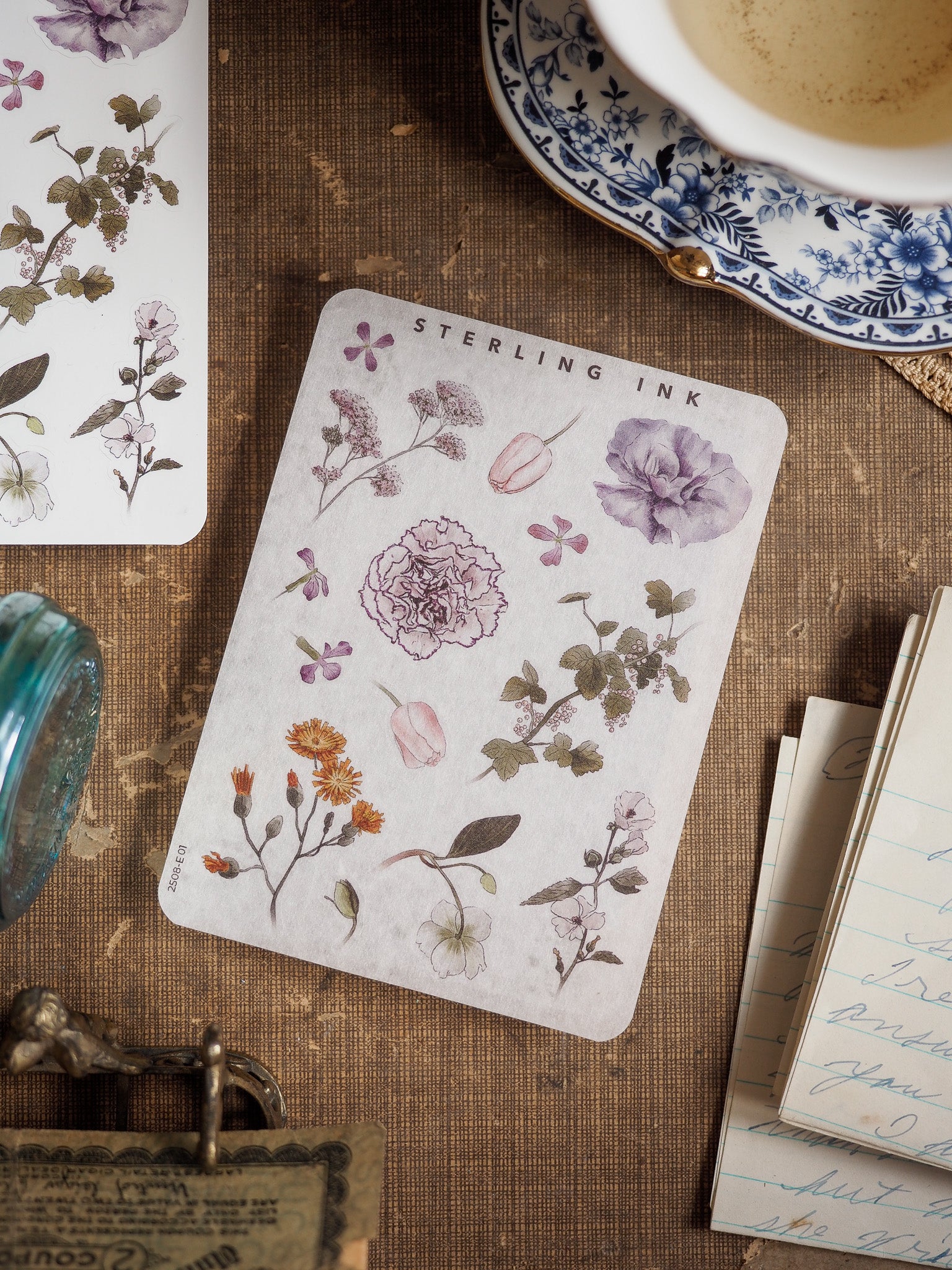 Botanical elements sticker sheet featuring watercolor illustrations of peonies, leaves, and assorted flowers in muted purple, sage green, and soft cream tones.