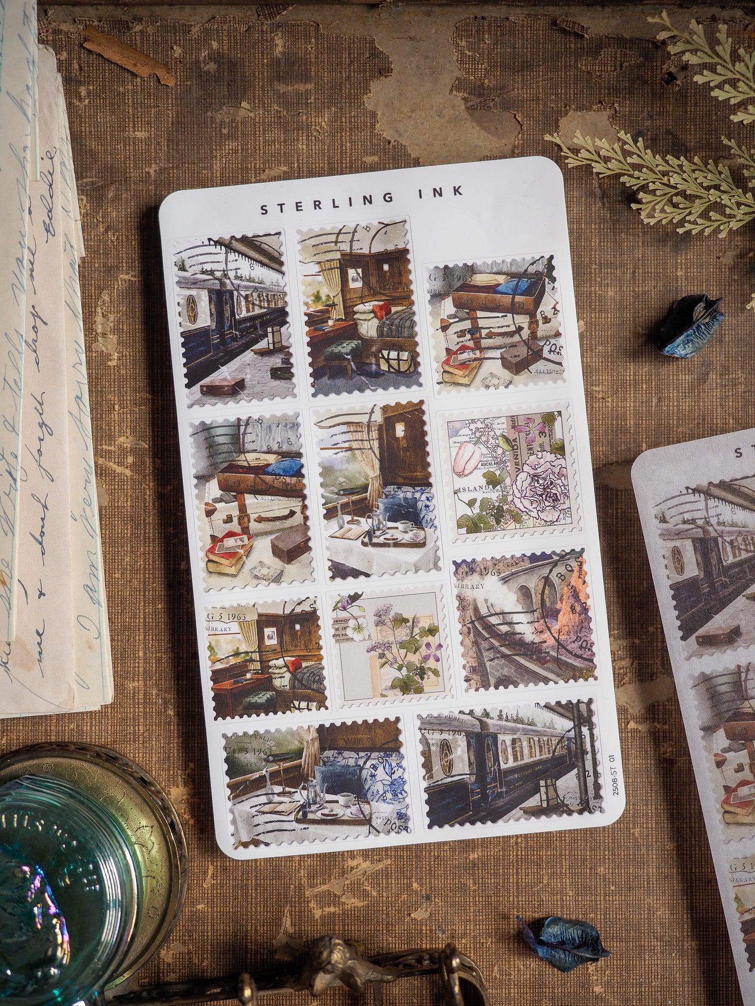 A vintage-themed "Sterling Ink" sticker sheet featuring a grid of nostalgic illustrations depicting historical scenes, old buildings, and train stations.
