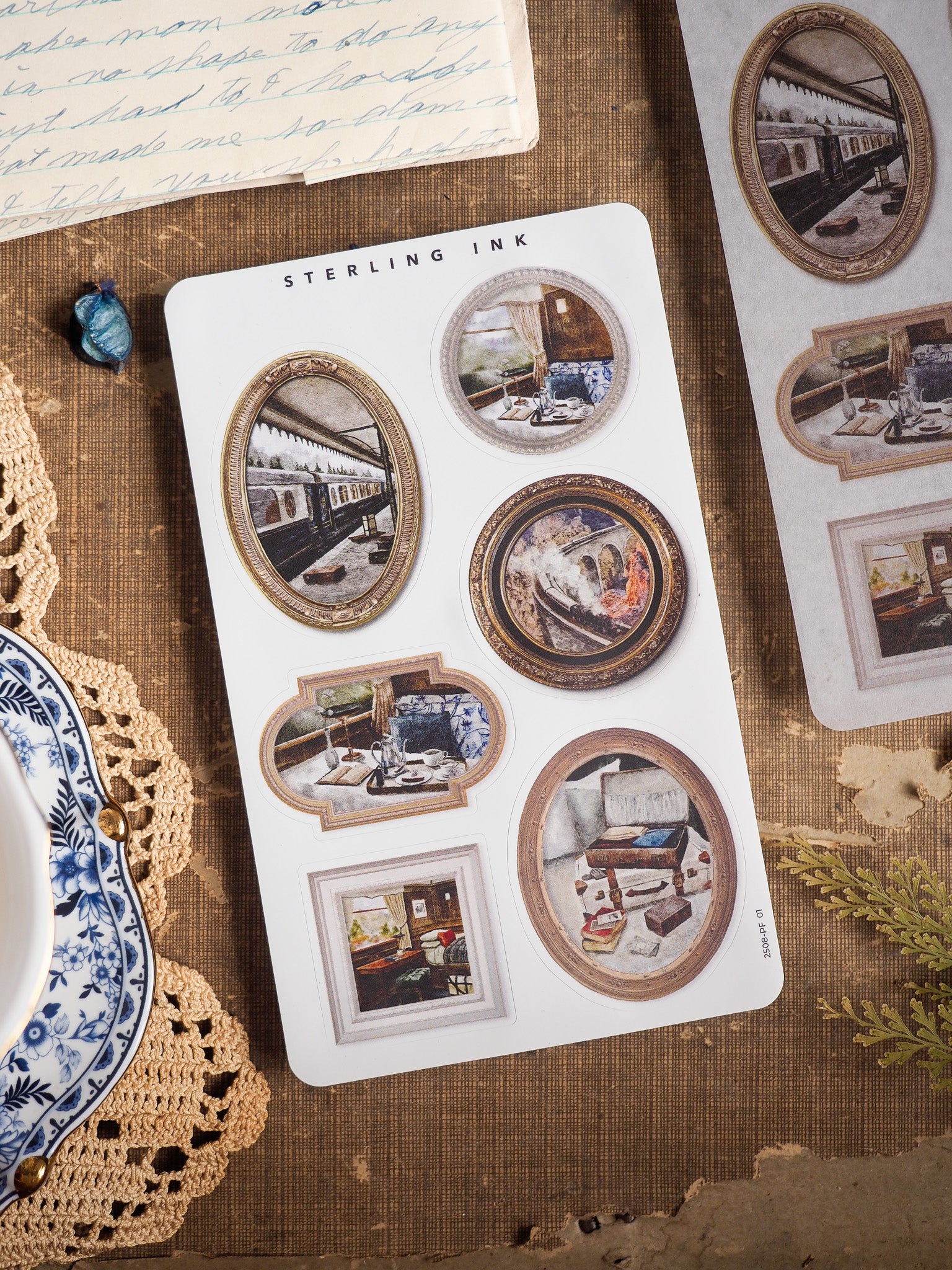 Sterling Ink sticker sheet featuring vintage, ornate photo frame borders with nostalgic images of trains, homes, and rustic scenes.