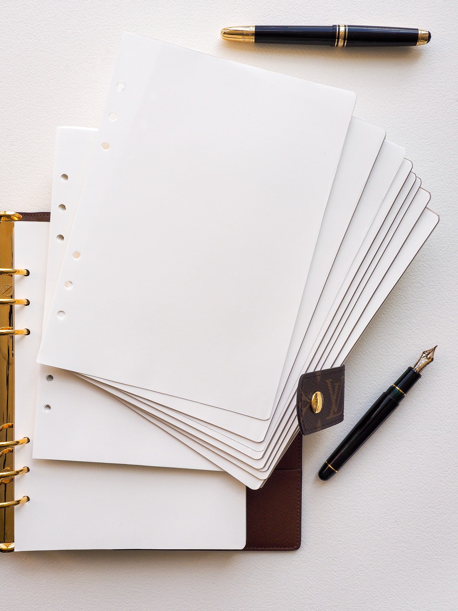 Stack of crisp, plain white loose leaf ring insets made from high-quality Tomoe River paper, perfect for versatile journaling and customizable note-taking.
