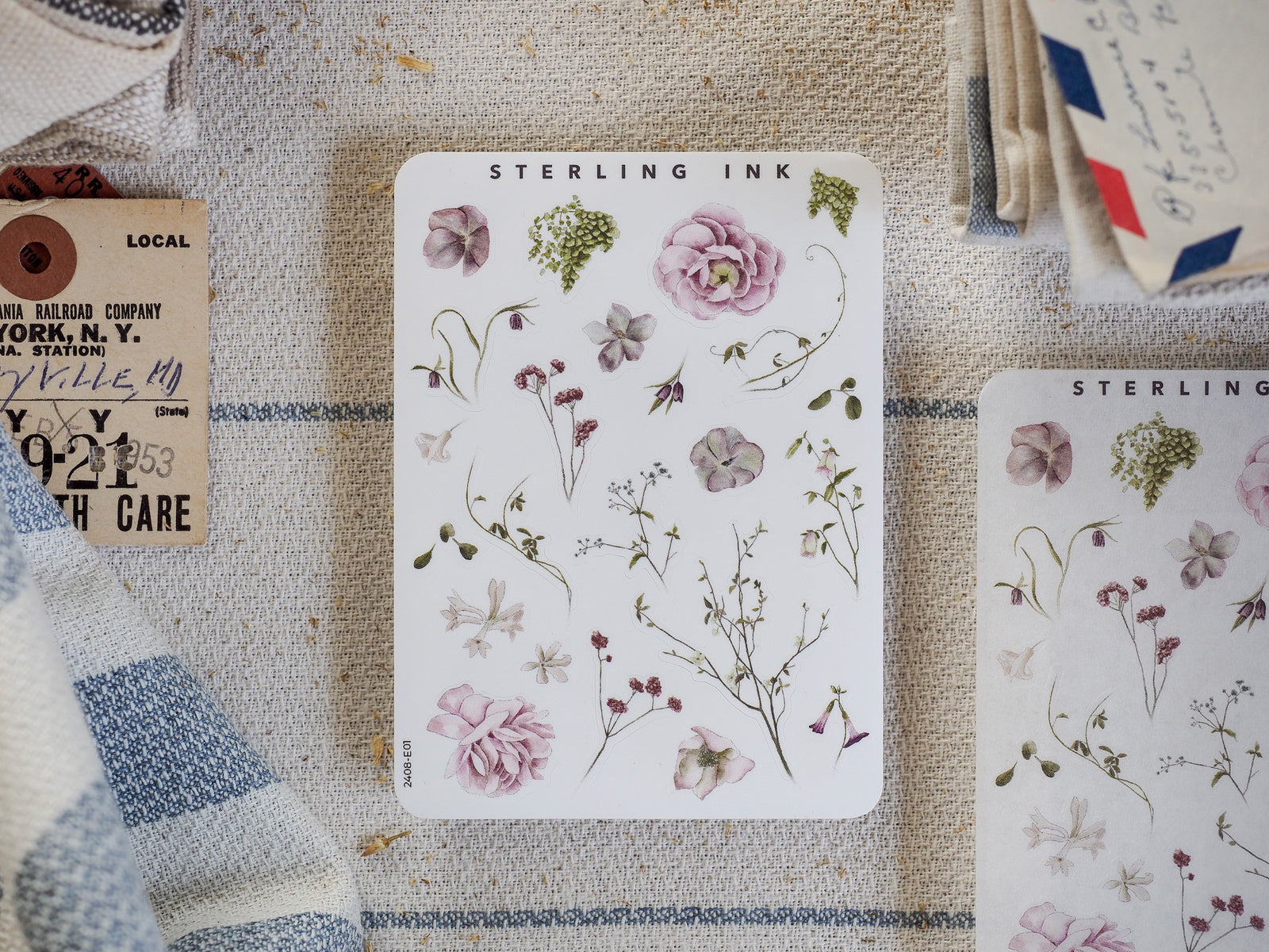 Watercolor sticker sheet featuring delicate botanical elements, including soft pink roses, trailing wildflowers, and various muted green leaves for themed journaling.