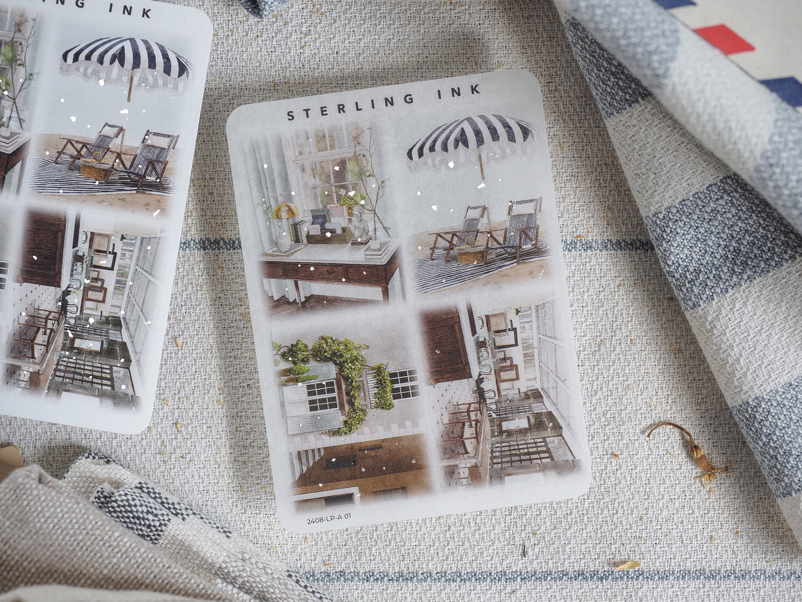 Decorative sheet of large silver foil illustration stickers featuring vintage summer scenes, including porches, outdoor chairs, and striped umbrellas.