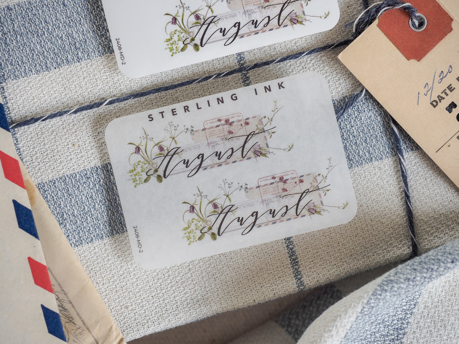 Elegant August monthly sticker sheets featuring botanical borders of delicate blush flowers and trailing green vines, perfect for journaling and planning.