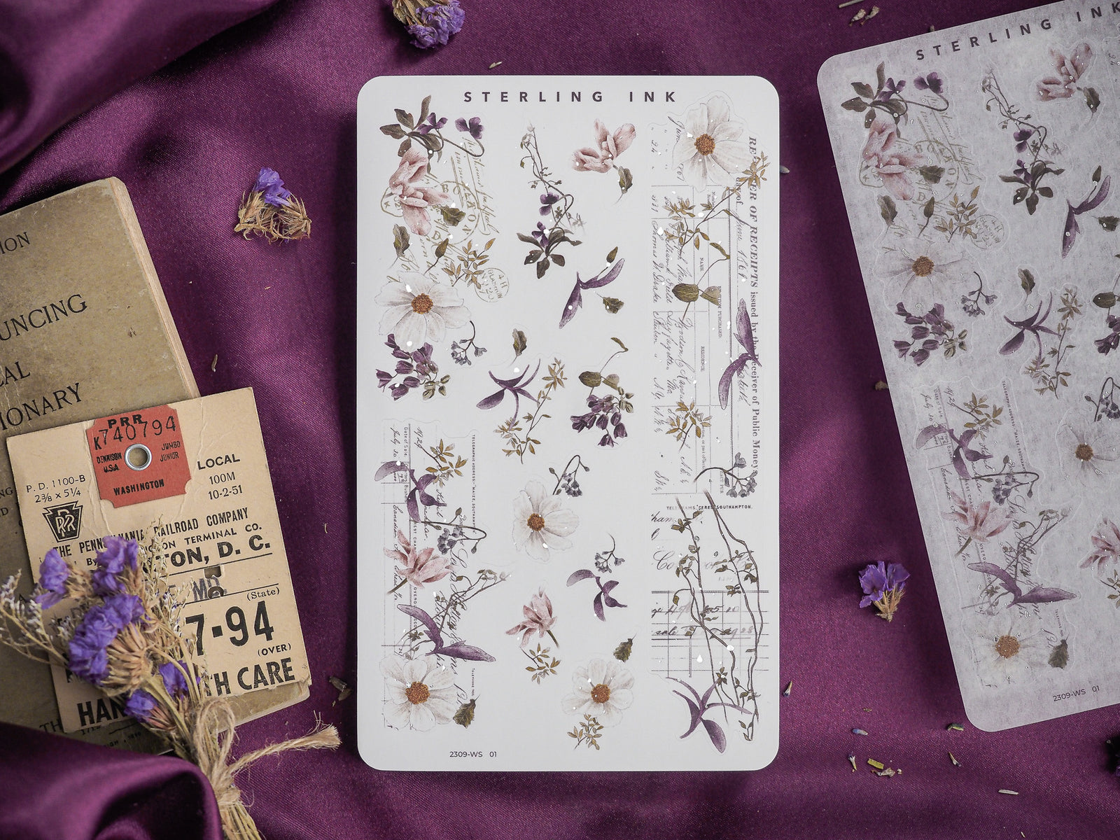 Detailed washi sticker featuring vintage botanical drawings of delicate flowers and greenery in muted, antique watercolor tones for scrapbooking or journaling.