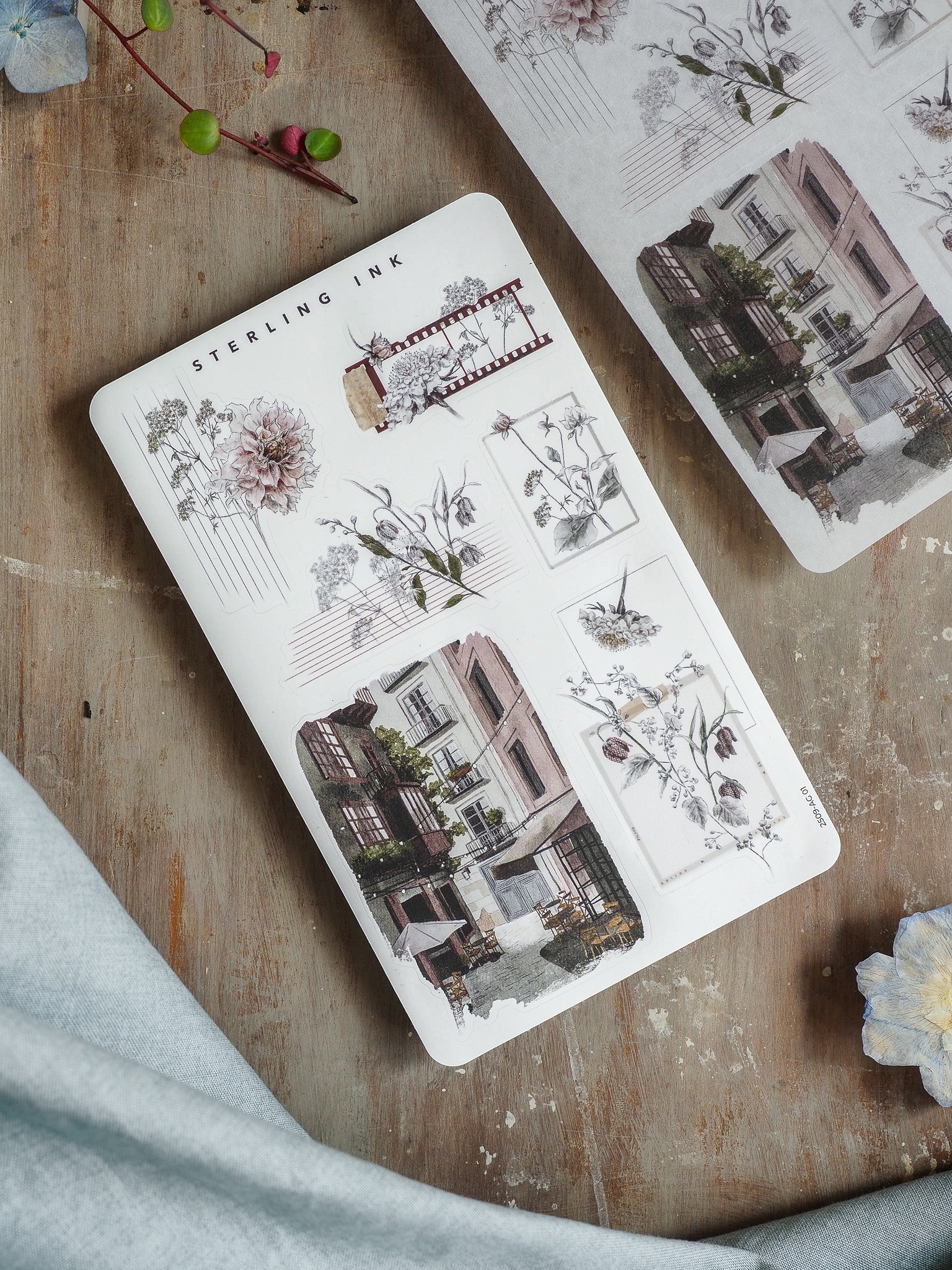 Detailed sticker sheet featuring vintage botanical illustrations and elegant Parisian architectural drawings for September 2025 planning.