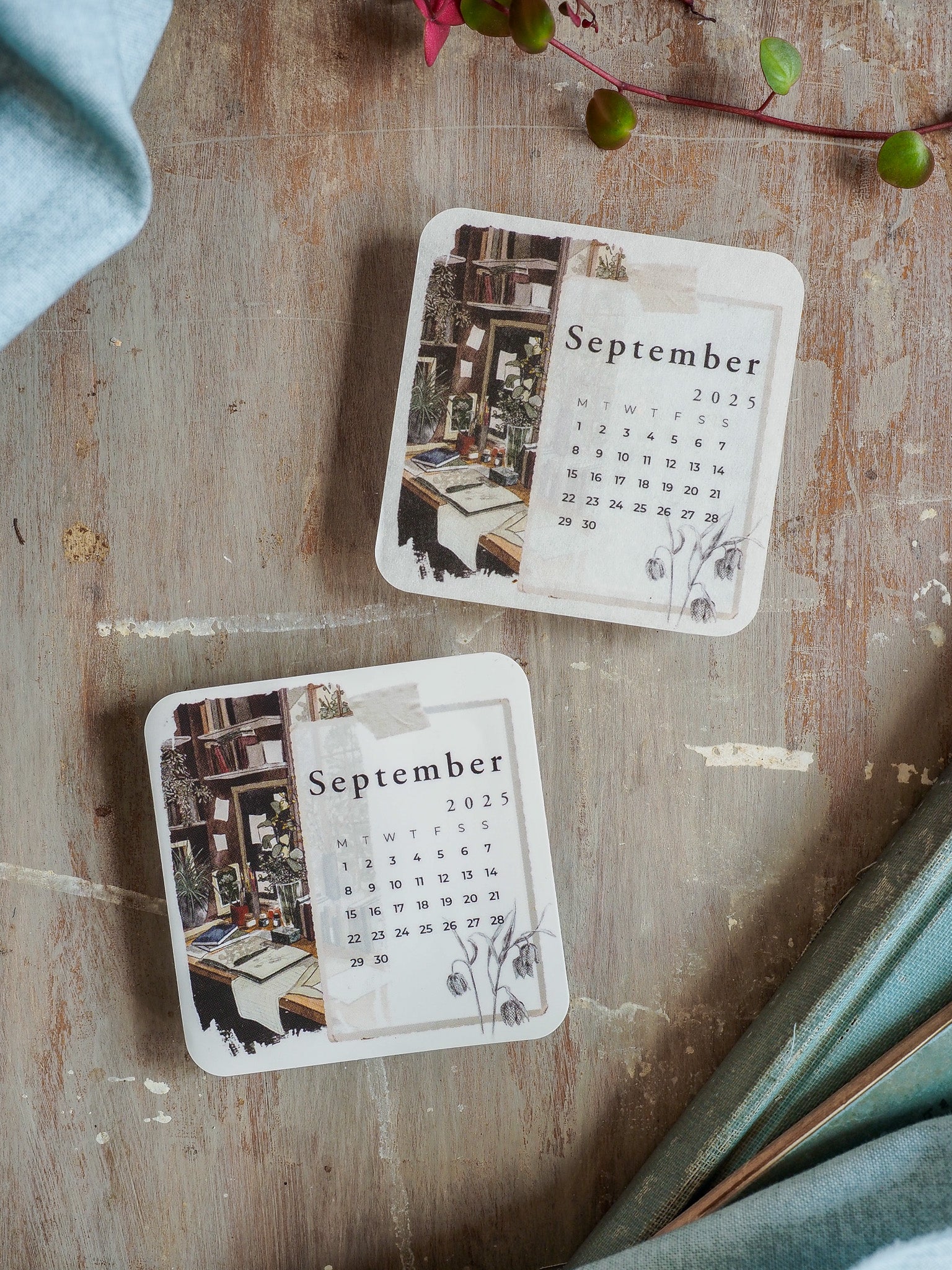 Vintage monthly calendar card featuring September 2025 dates and a rustic illustration of a library interior, printed in muted, earthy tones.
