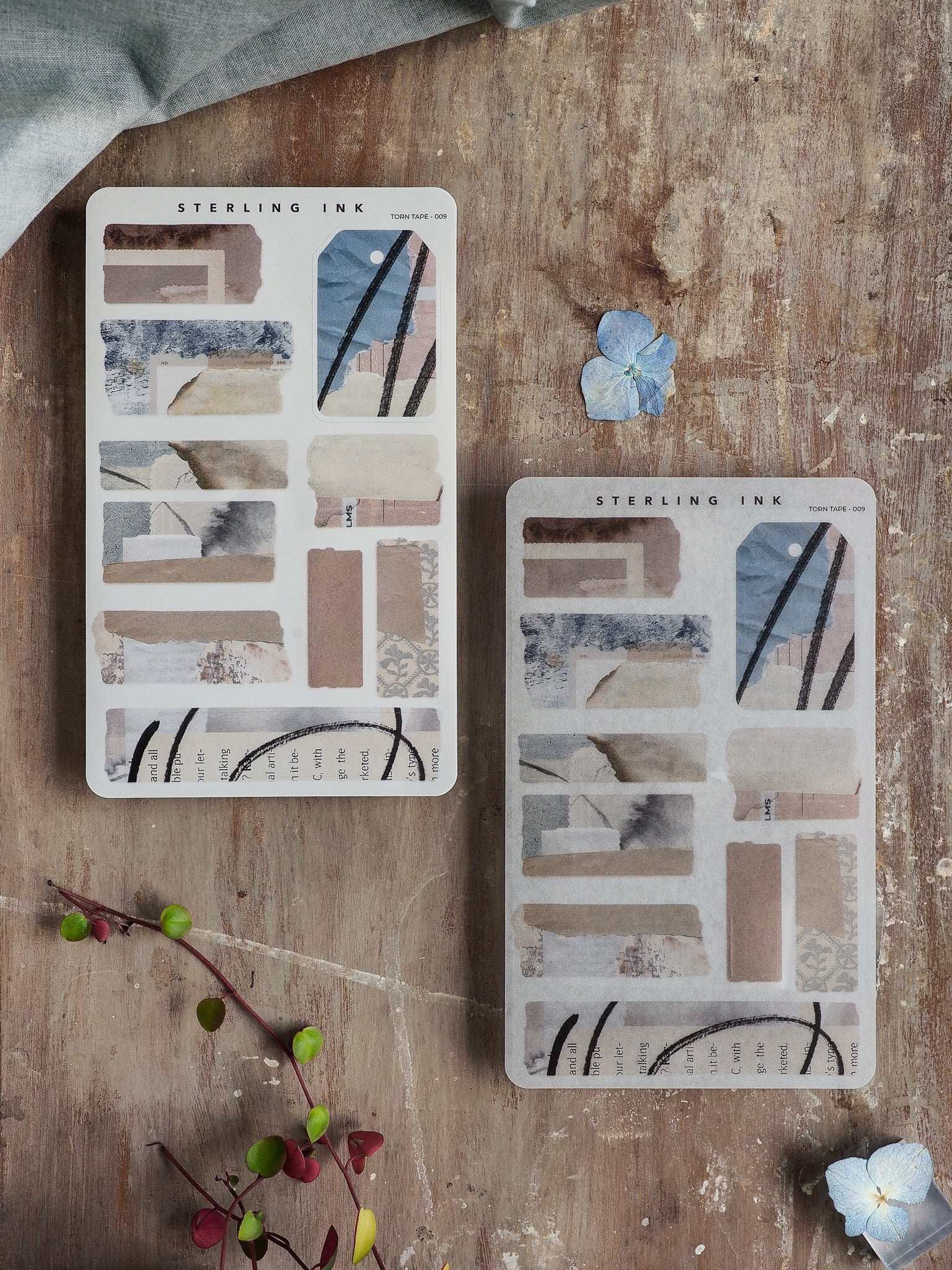 Sheets of abstract torn tape stickers featuring strips in muted, neutral tones, including beige, dusty blue, and soft gray, perfect for journaling.