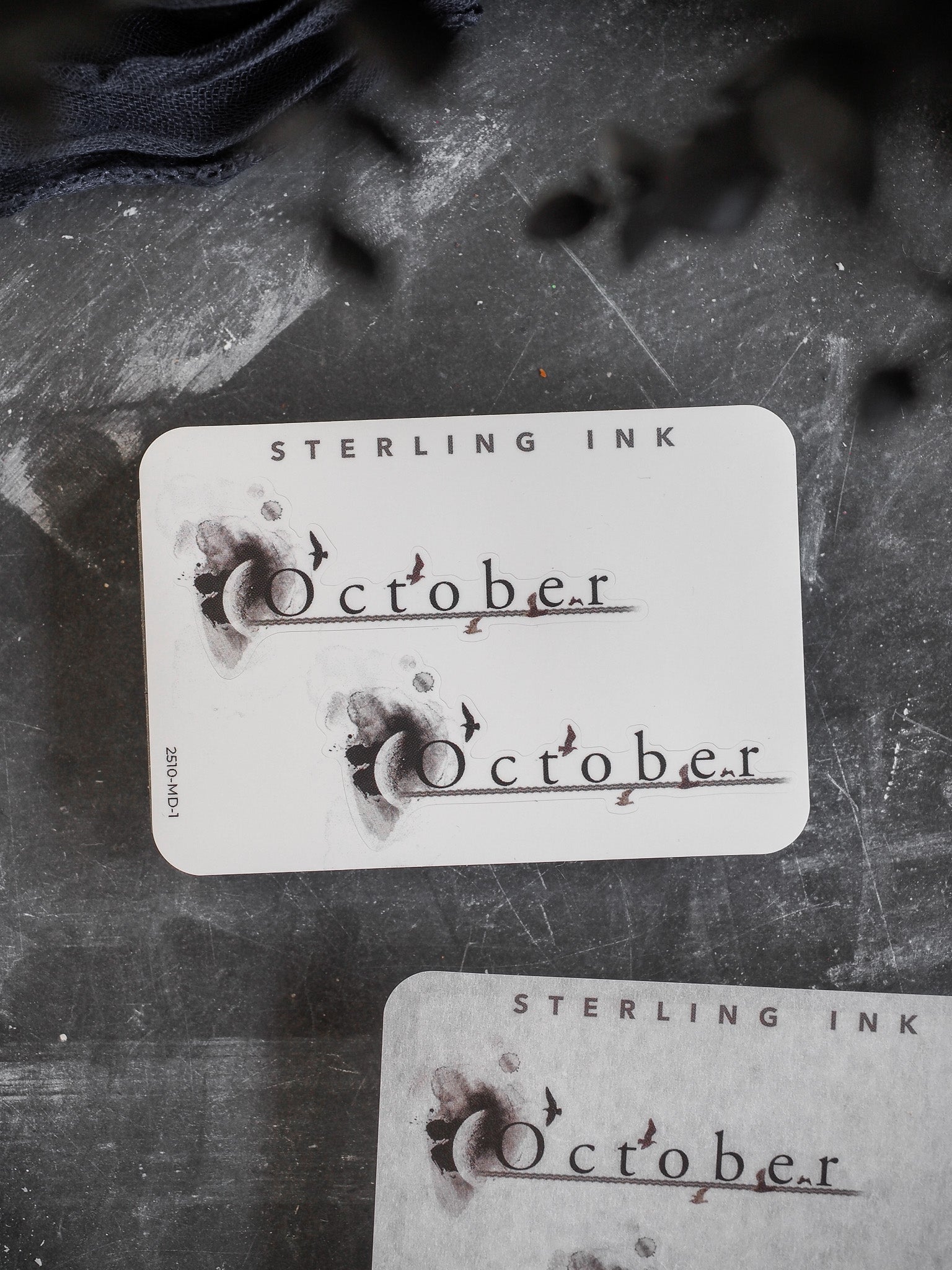 Rustic, cream-colored monthly planner sticker featuring elegant, calligraphic script that reads "October," designed for seasonal journaling.
