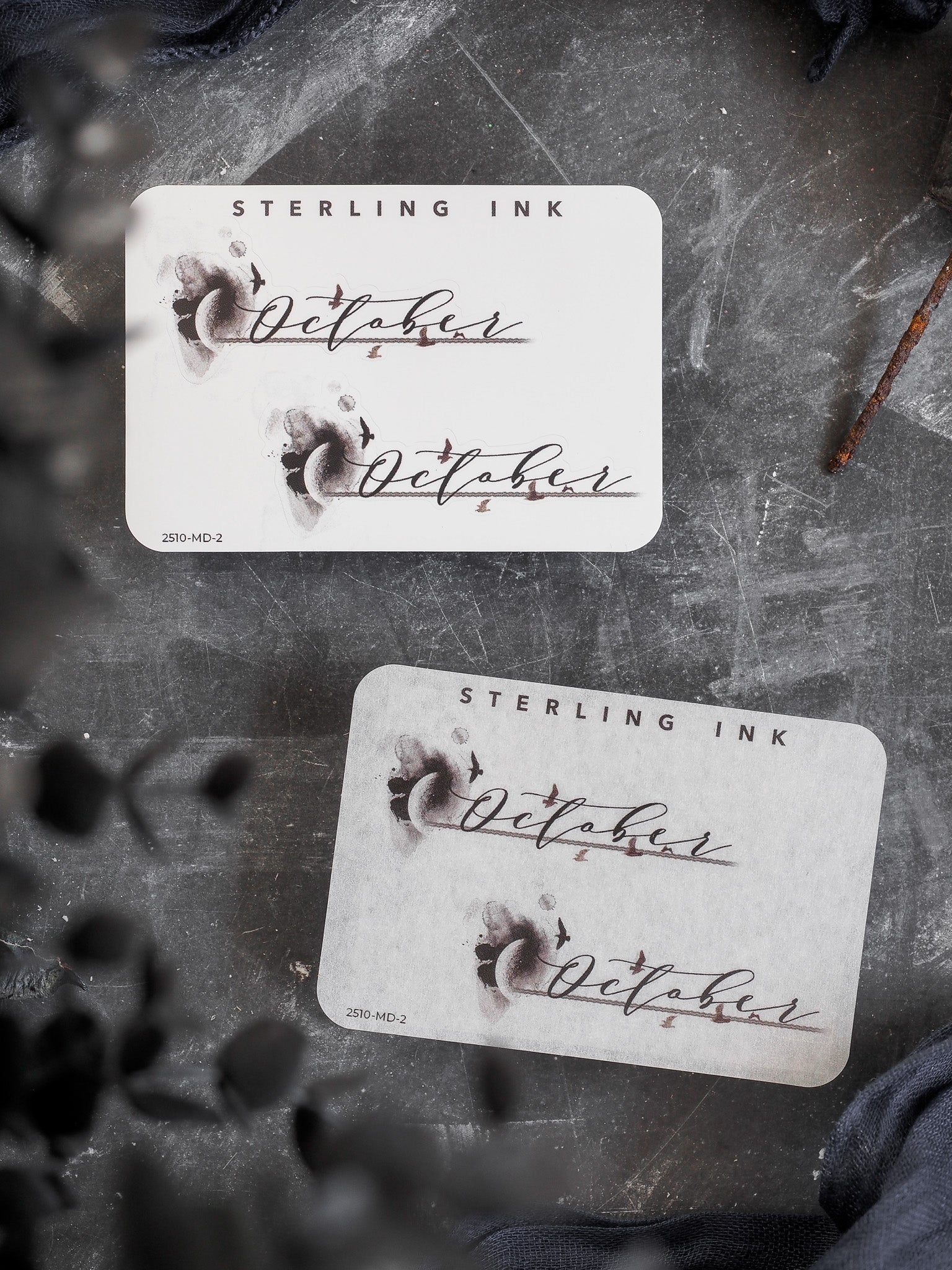 Decorative label featuring the name "October" in elegant script lettering, set within a soft watercolor wash design, suitable for themed journaling or planning.