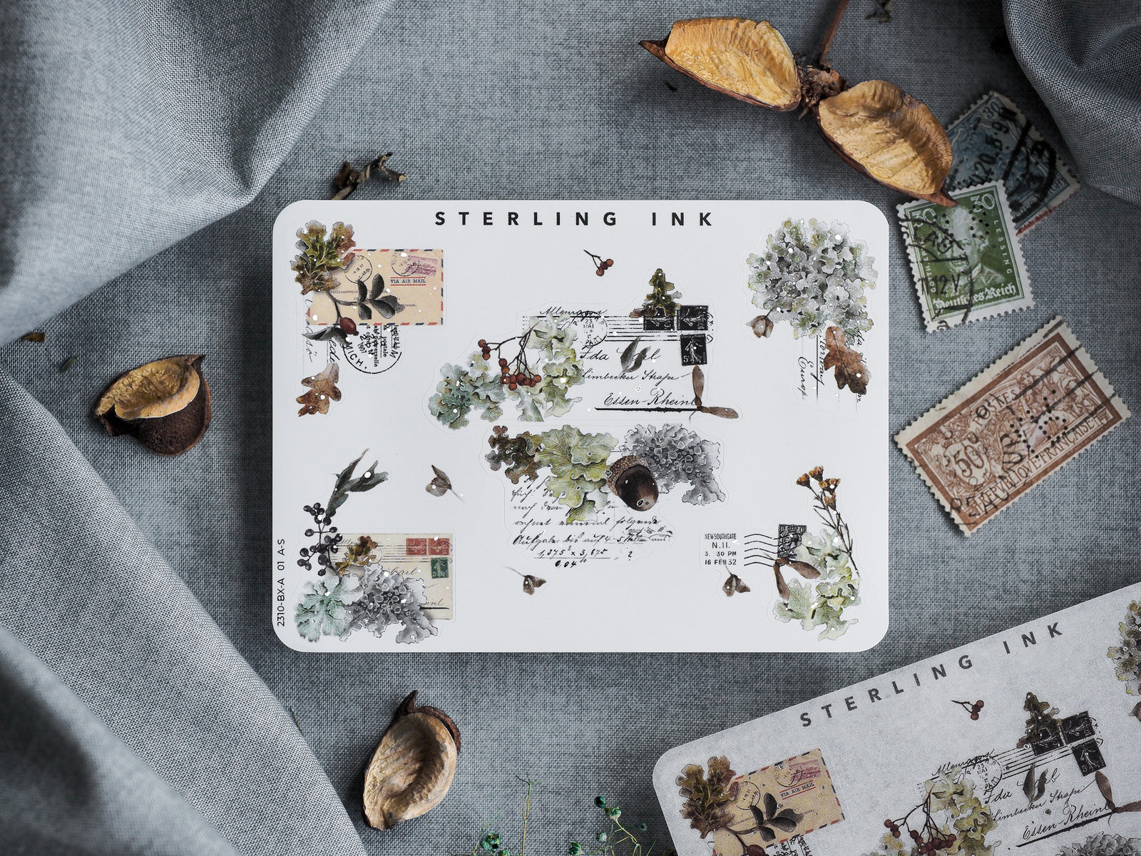 Autumnal "Edges and Corners Stickers (Silver Foil) - October 2023," featuring a cluster of vintage stamps, delicate leaves, and rustic decorative illustrations on white paper.