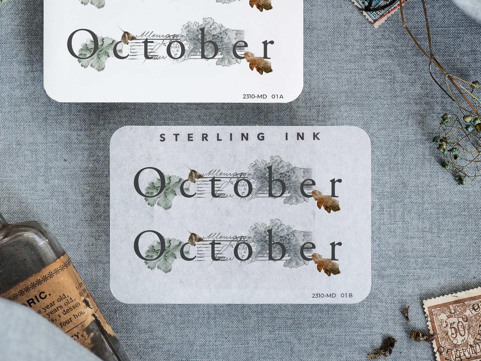 Rustic watercolor sticker for October, featuring the word "October" surrounded by delicate autumn foliage and earth-toned greenery.