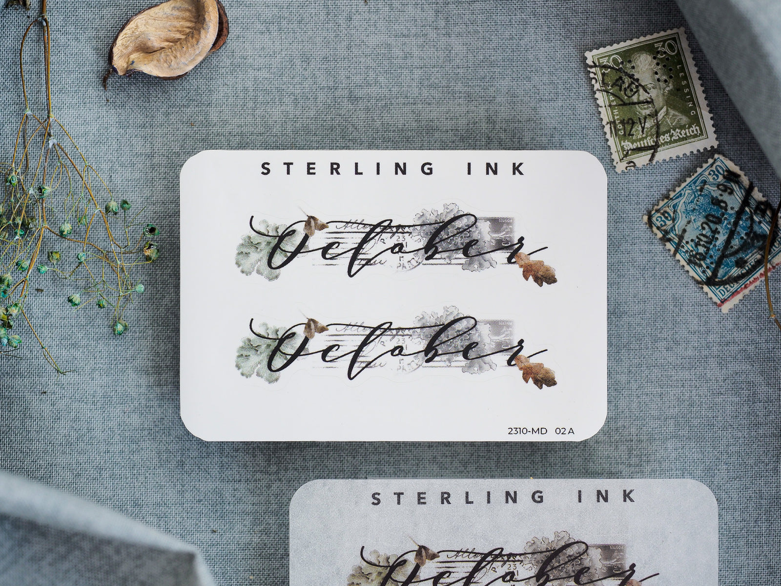 Elegant autumn-themed October calligraphy sticker featuring muted watercolor accents and a sophisticated design for journaling and scrapbooking.