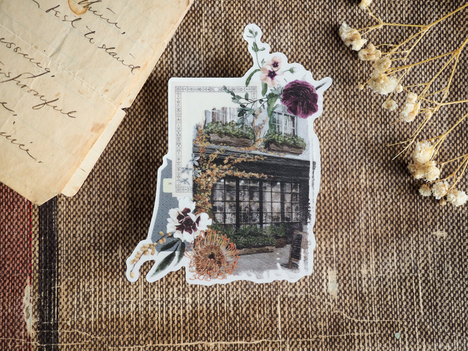 Decorative clear vinyl sticker featuring an autumnal illustration of a lush, vine-covered greenhouse window displaying rich purple and deep red blooms.