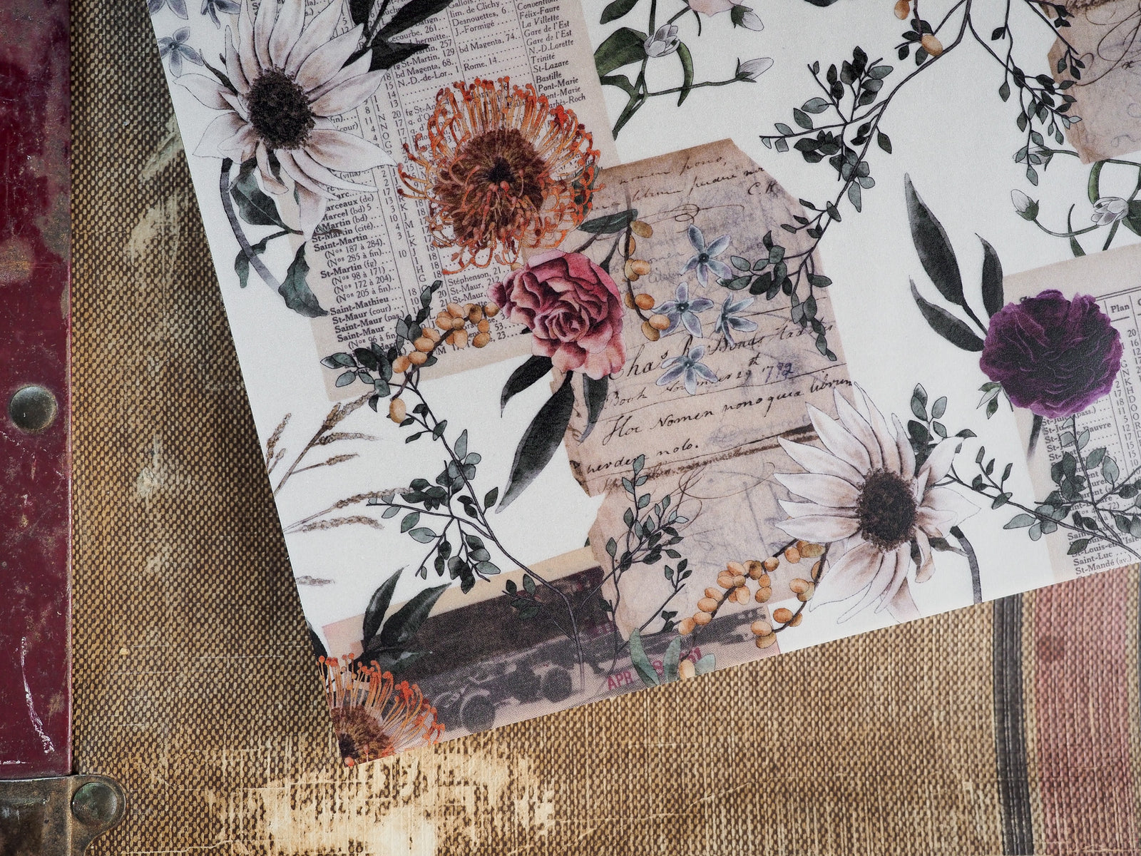 Autumn-themed monthly calendar page with intricate botanical illustrations featuring deep-toned roses, dahlias, and rich autumnal foliage on cream vellum paper.