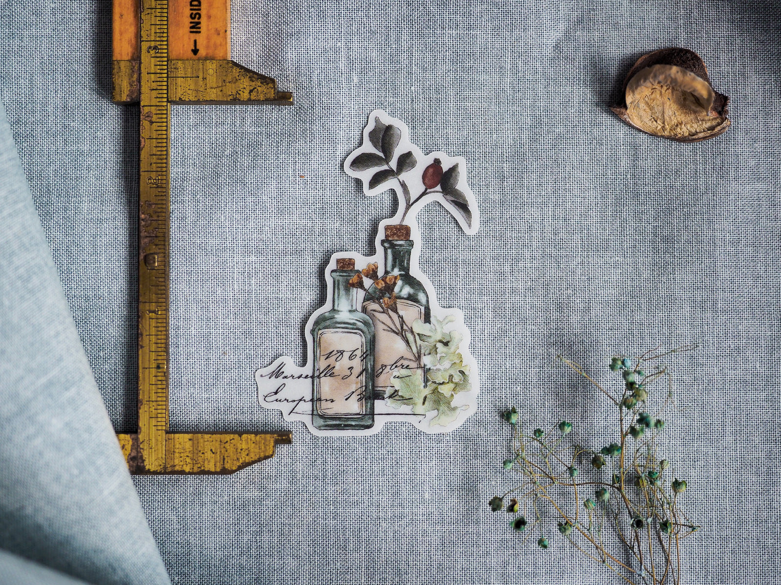 Autumnal die-cut sticker set featuring rustic glass bottles, delicate botanical illustrations, and vintage handwritten text for October 2023 planning.