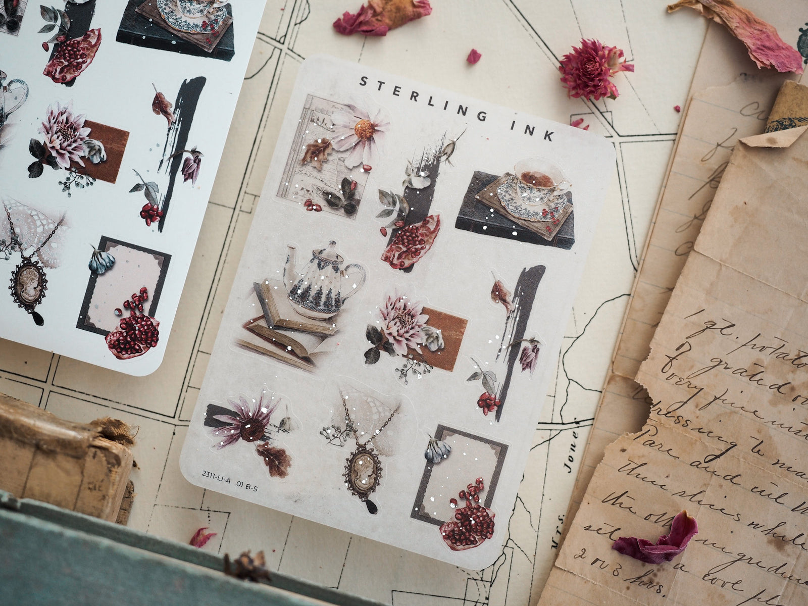 Botanical sticker sheet featuring dried florals, berries, and dark botanical elements accented with scattered silver foil for a vintage, moody aesthetic.