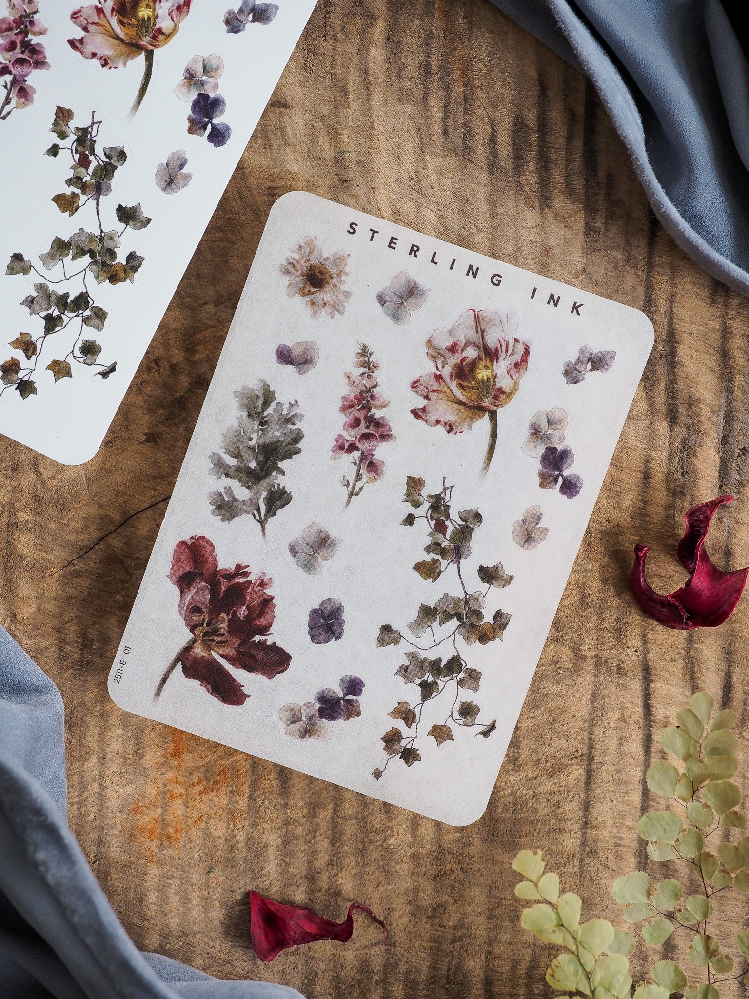 Watercolor botanical sticker sheets featuring a rich arrangement of purple and pink blooms, delicate leaves, and swirling vines perfect for creative crafting.