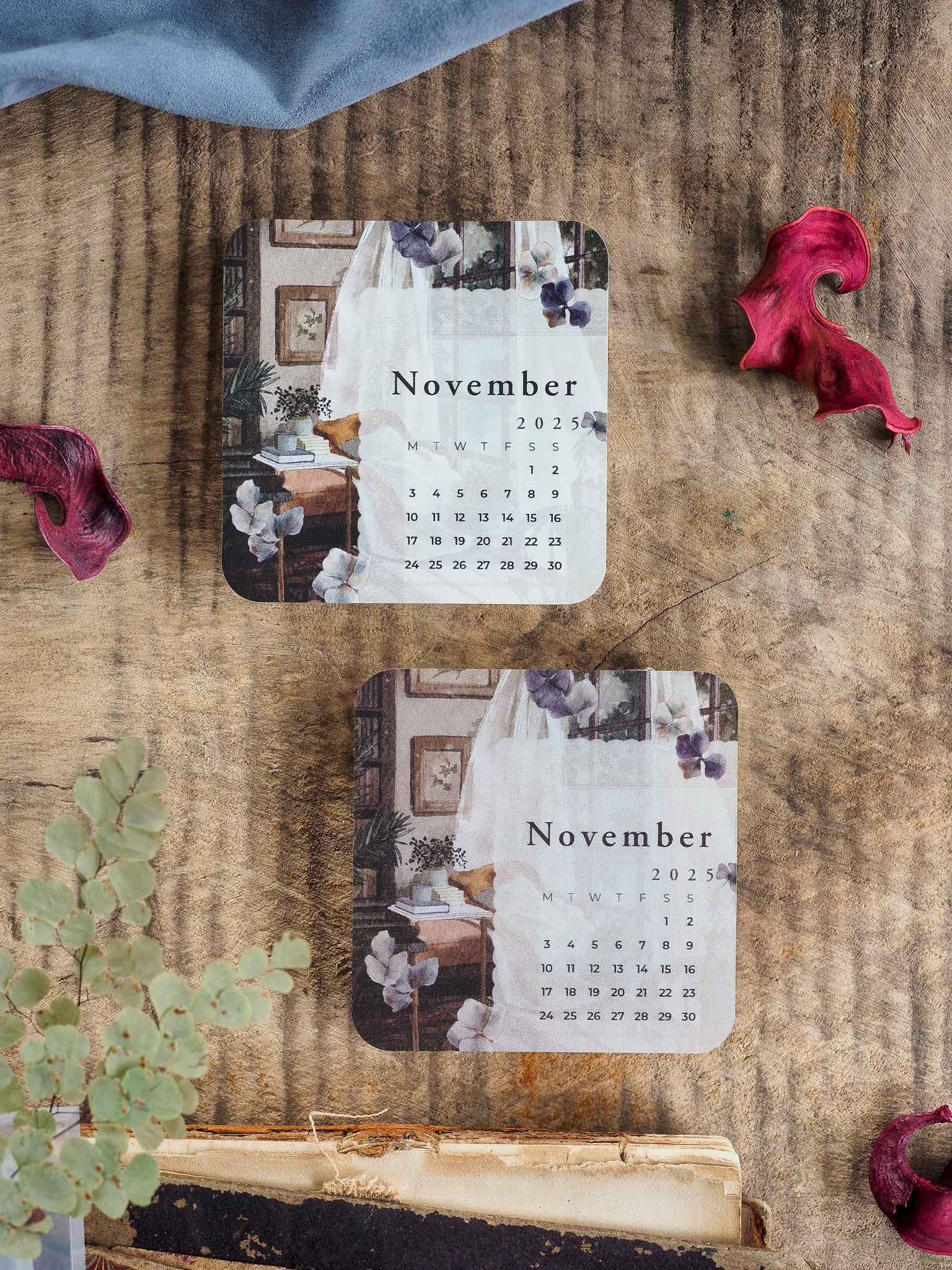 Decorative November 2025 monthly calendar grid with a rustic, vintage aesthetic featuring framed artwork and warm, muted tones.
